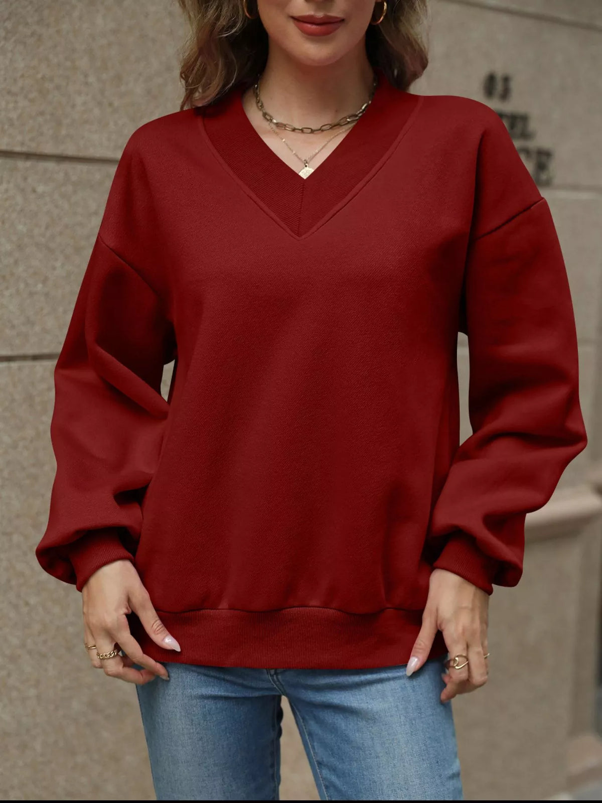 V-neck solid color casual sweatshirt from Trendsi, featuring a relaxed fit and comfortable fabric, shown in the product image.