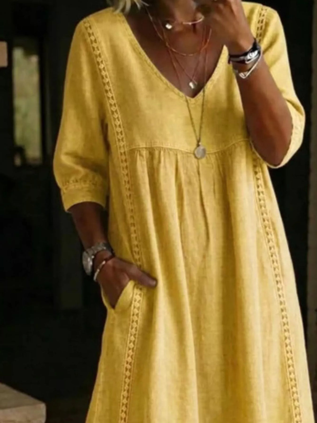 Plus size full-length midi dress with V-neck and 3/4 sleeves by Trendsi, shown in a stylish, flowing fabric.