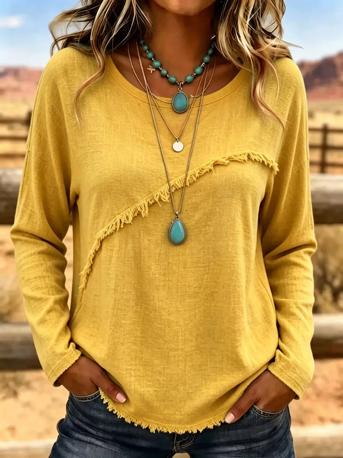Plus size long sleeve fringe detail T-shirt from Trendsi, featuring a comfortable fit and stylish fringe accents on the sleeves.