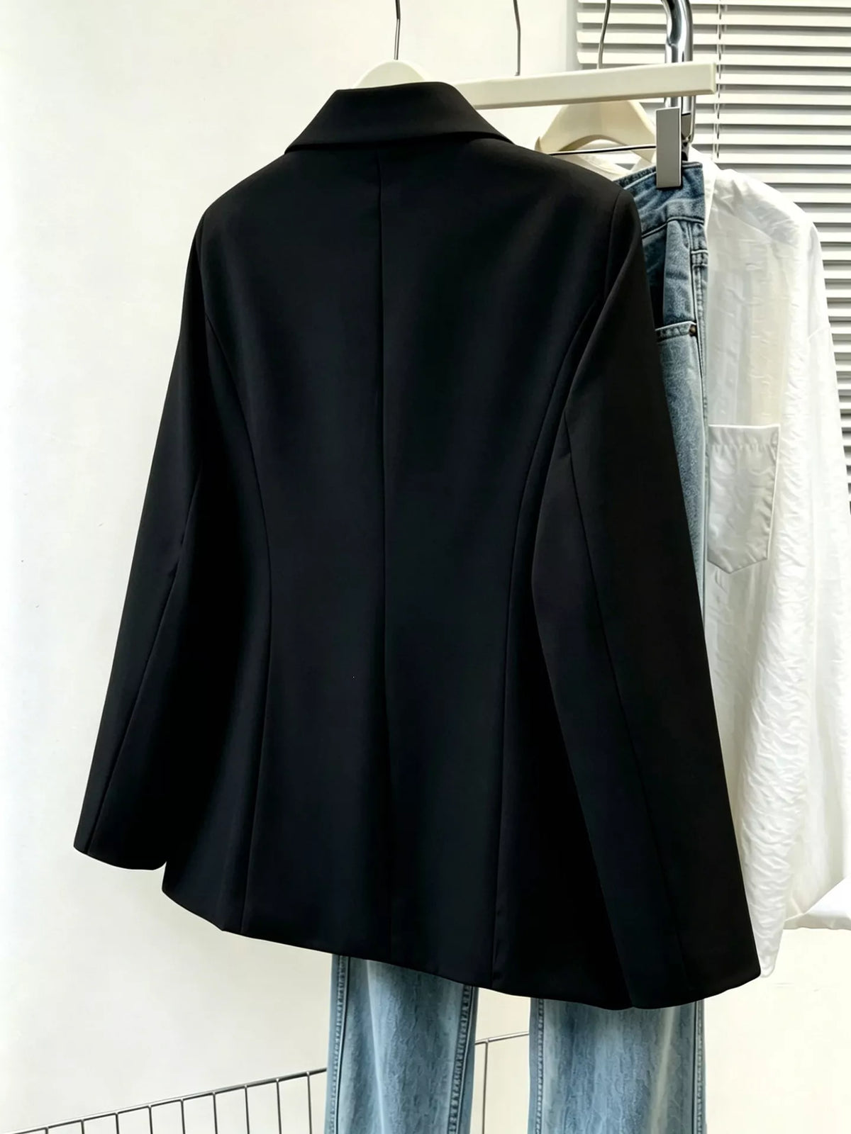 Plus size casual blazer with lapel collar, single-breasted design, in black fabric, from Trendsi.