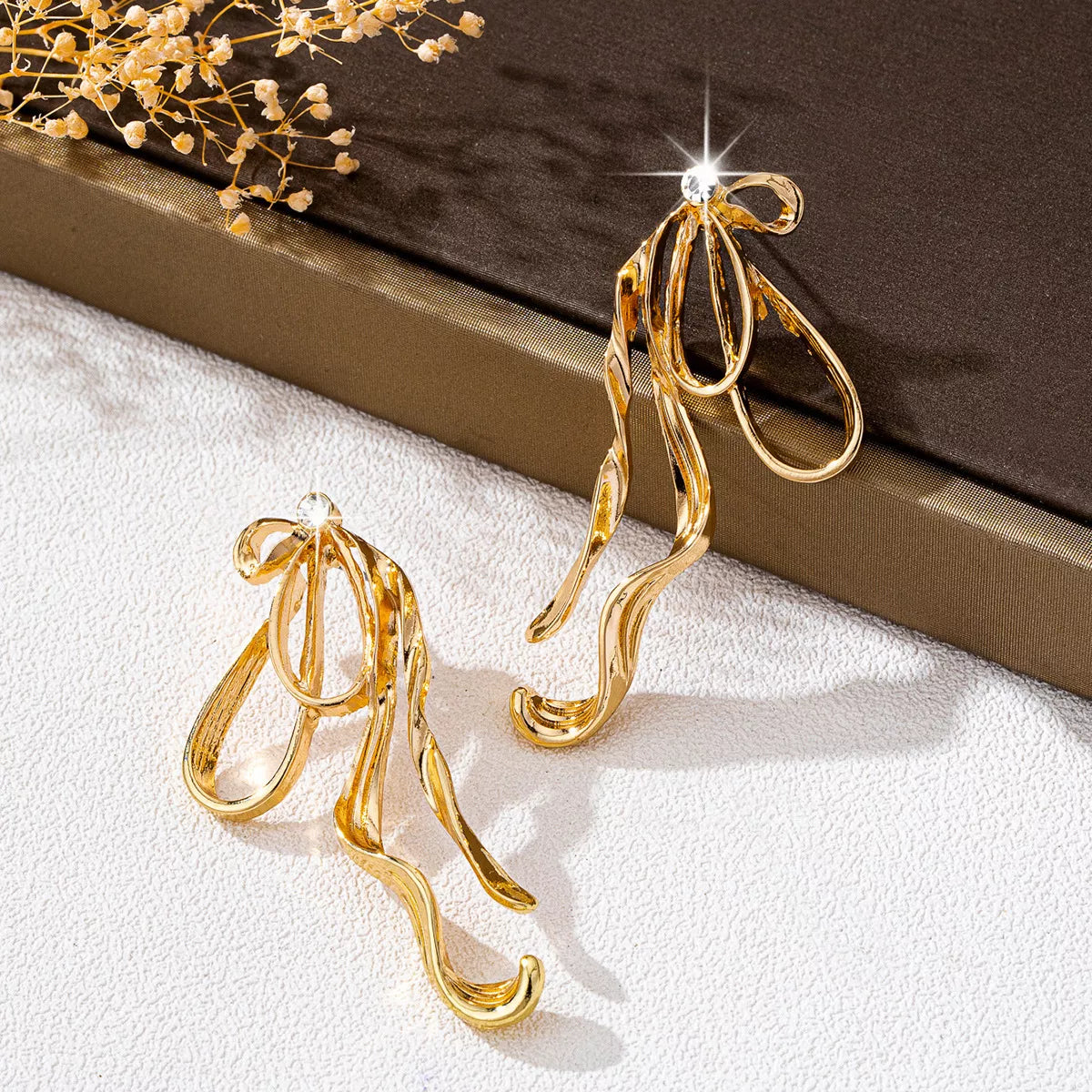 Gold-plated bow earrings from Plush Fashion Hub, featuring a stylish and elegant design in 18K gold plating.