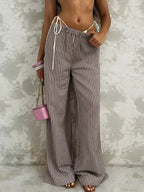 Striped wide-leg pants from Trendsi featuring a tied waist and relaxed fit, perfect for casual and stylish outfits.
