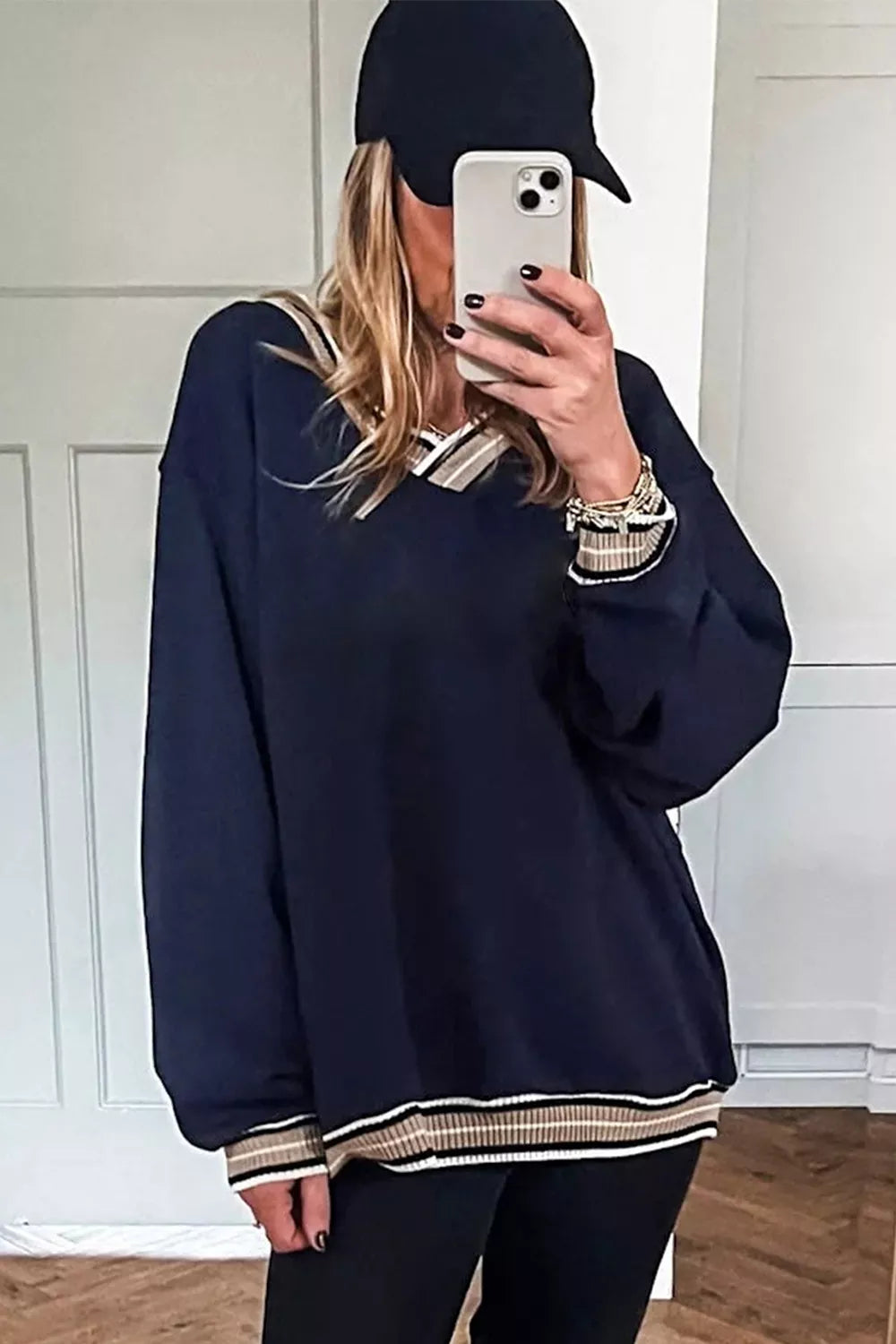 Contrast striped trim V-neck sweatshirt by Trendsi featuring a cozy fit and stylish design, shown in a neutral color.