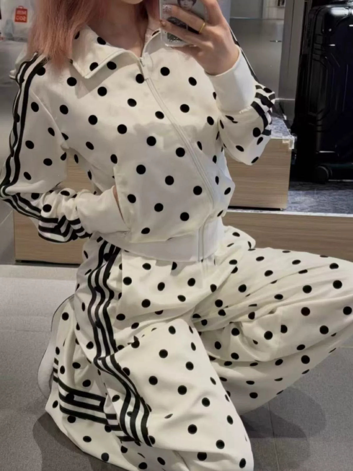 Polka dot zip-up outerwear and pants set by Plush Fashion Hub, featuring a matching polka dot design on a stylish, coordinated outfit.