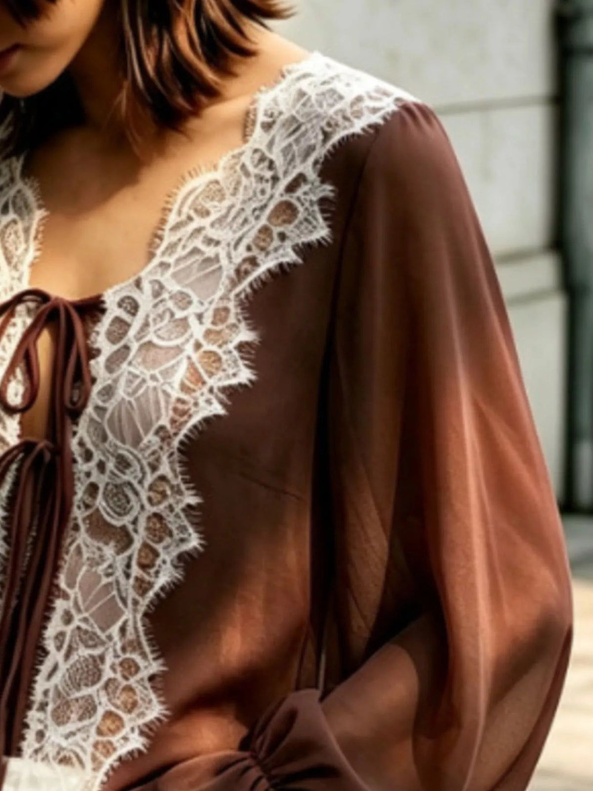 Sheer lace-trimmed front tie blouse for women, featuring delicate lace details and a stylish, feminine design.