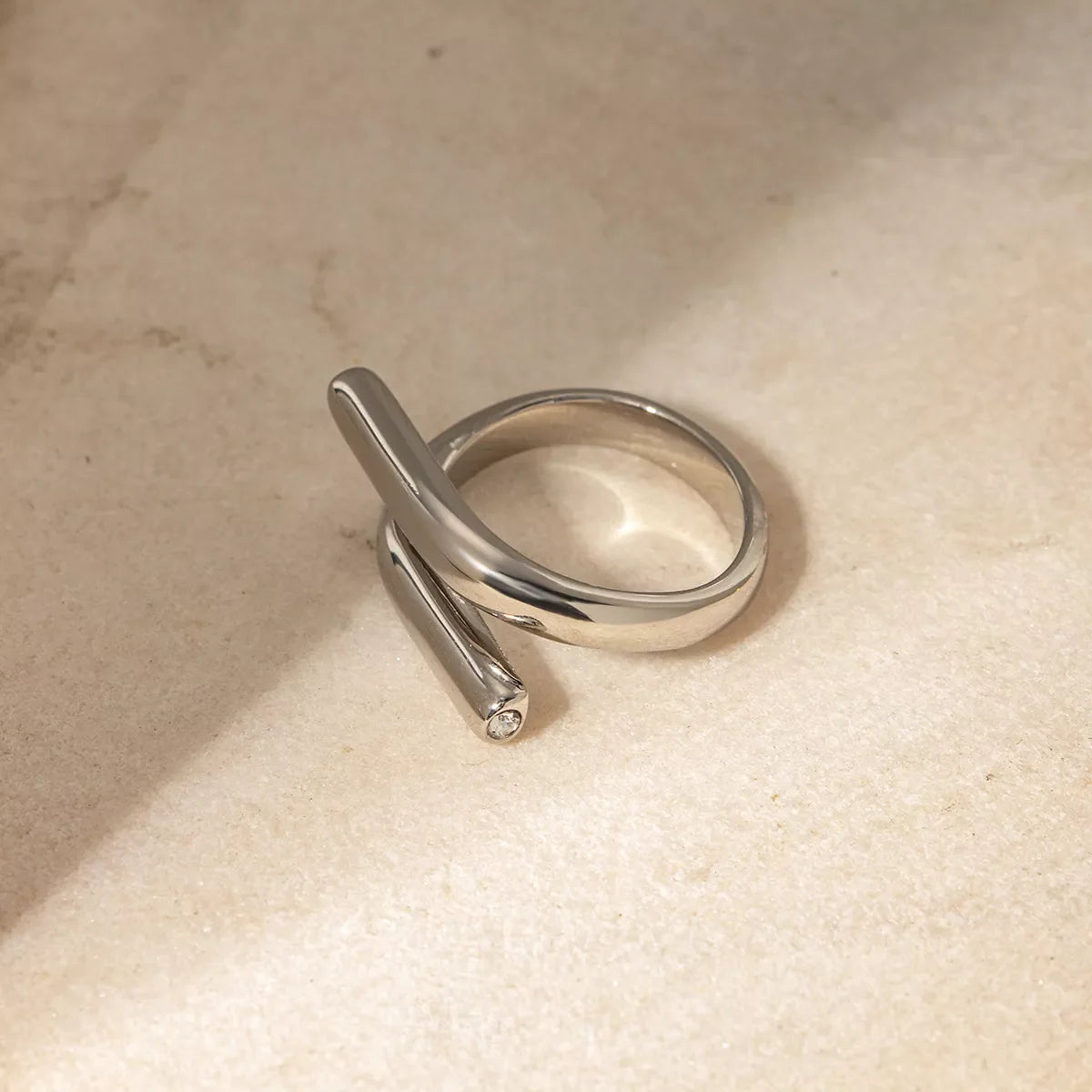 Stainless steel bypass ring from Plush Fashion Hub featuring a sleek, modern design with smooth, curved band.