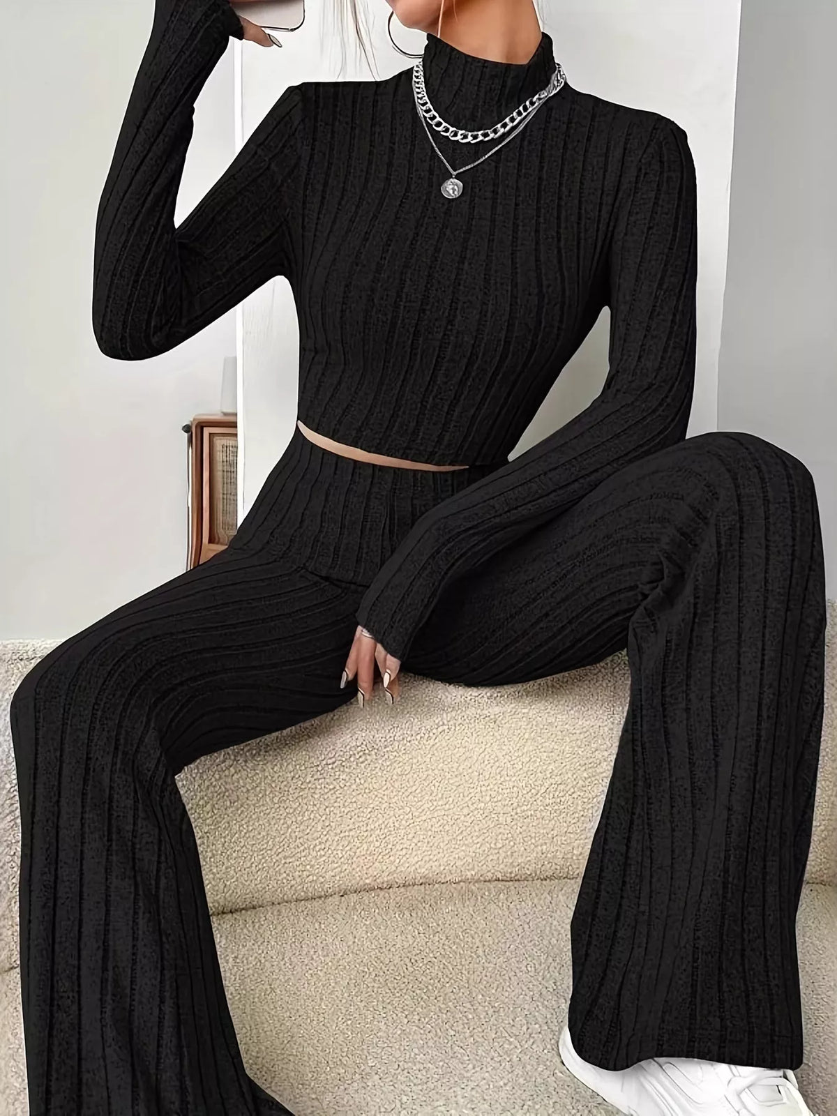 Ribbed turtleneck crop top and flare pants sweater set by Trendsi, featuring cozy knit fabric and stylish fit.