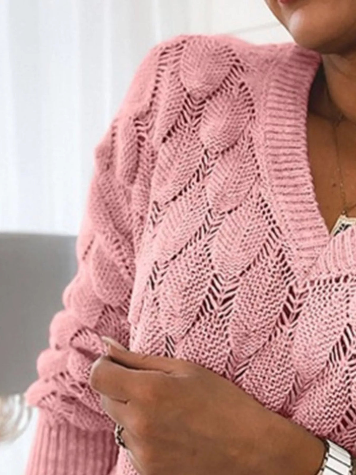 V-neck knitted sweater by Trendsi featuring a cozy, soft fabric in a classic design, displayed on a neutral background.