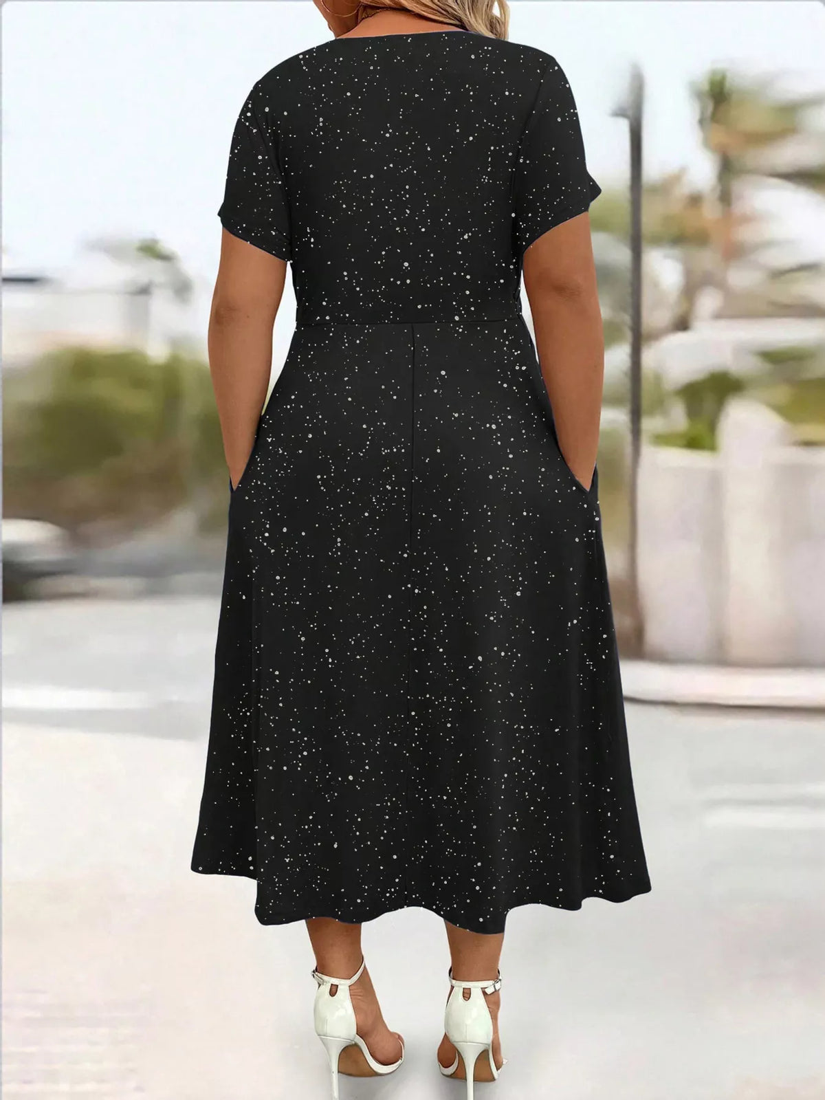 Plus size glitter flutter sleeve midi dress by Trendsi, featuring a shimmering fabric and flowing silhouette.