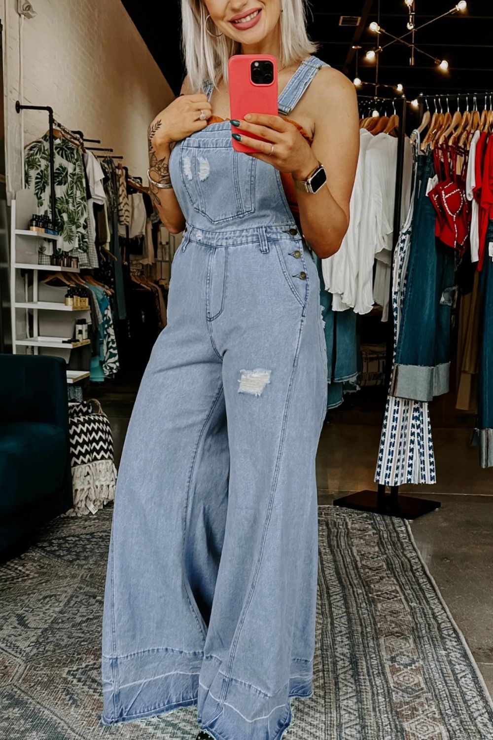 Women's distressed wide-leg denim overalls by Plush Fashion Hub, casual relaxed fit jeans with distressed details and adjustable shoulder straps.