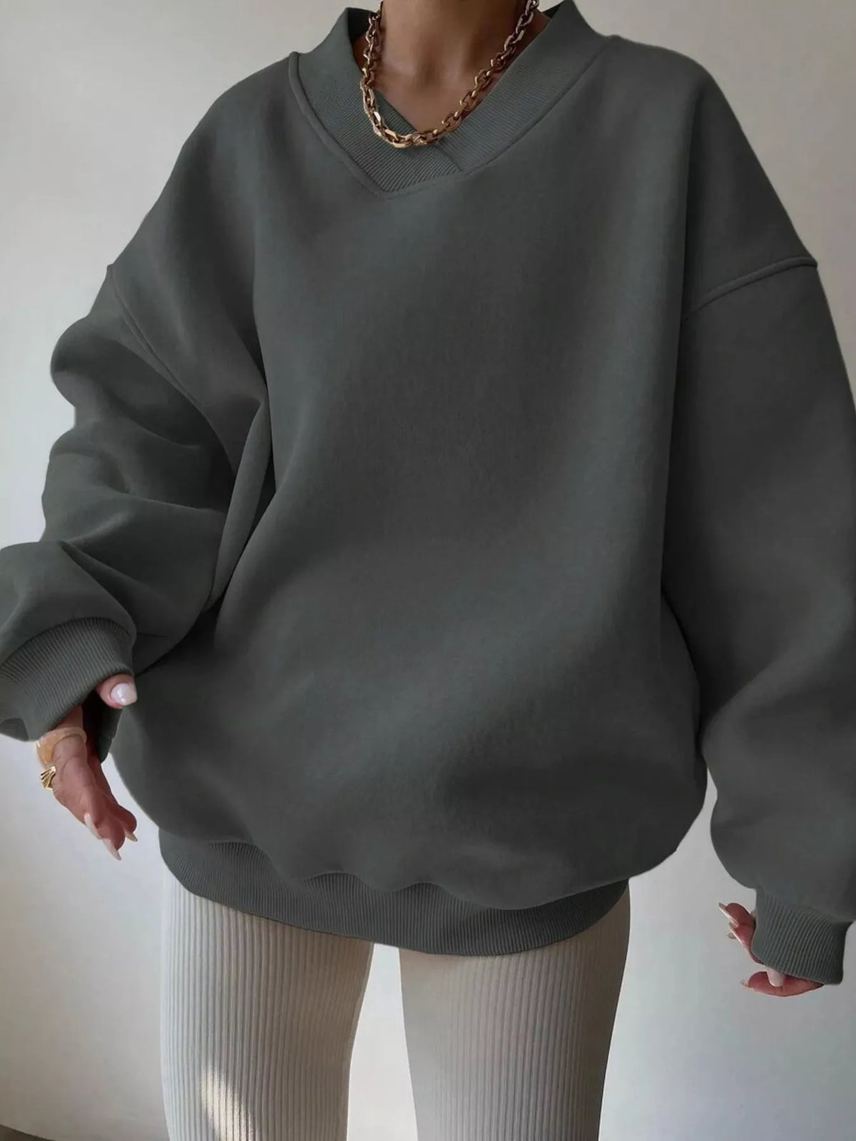 Oversized dropped shoulder long sleeve sweatshirt from Trendsi, featuring a relaxed fit and soft fabric in the image.