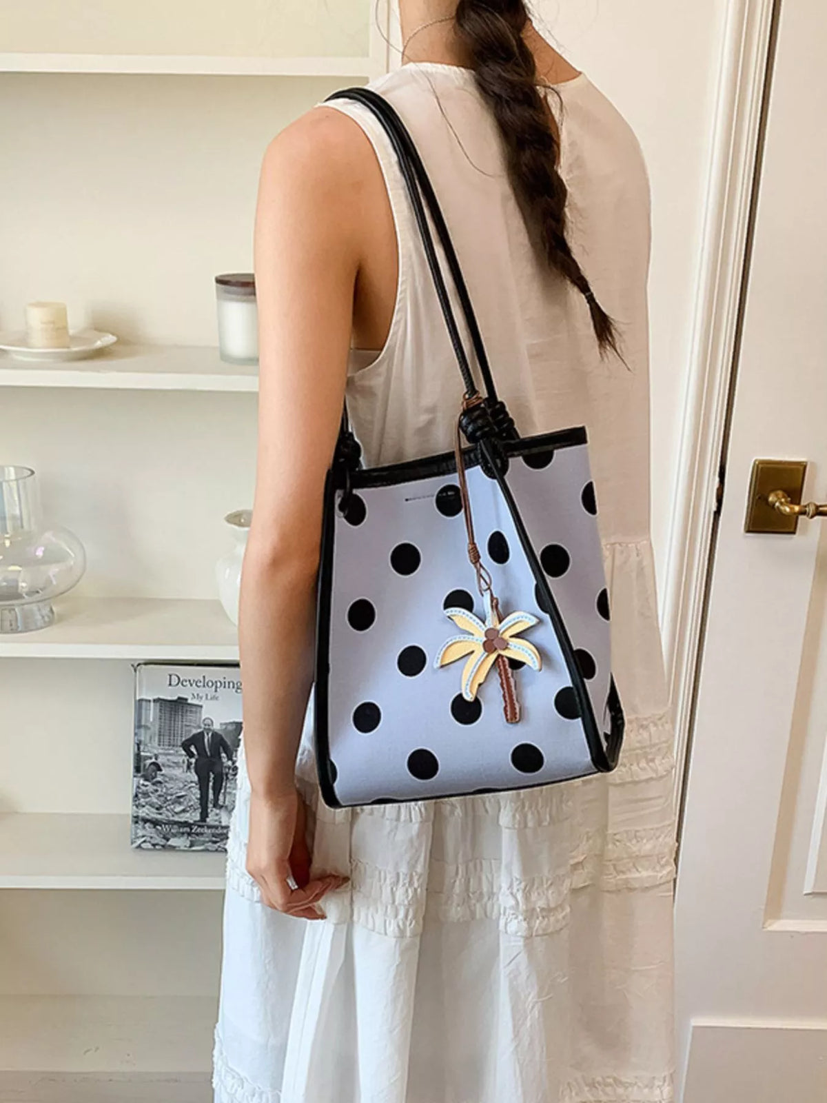 Polka dot shoulder handbag by Plush Fashion Hub with a sleek design, featuring a strap and spacious interior for everyday use.