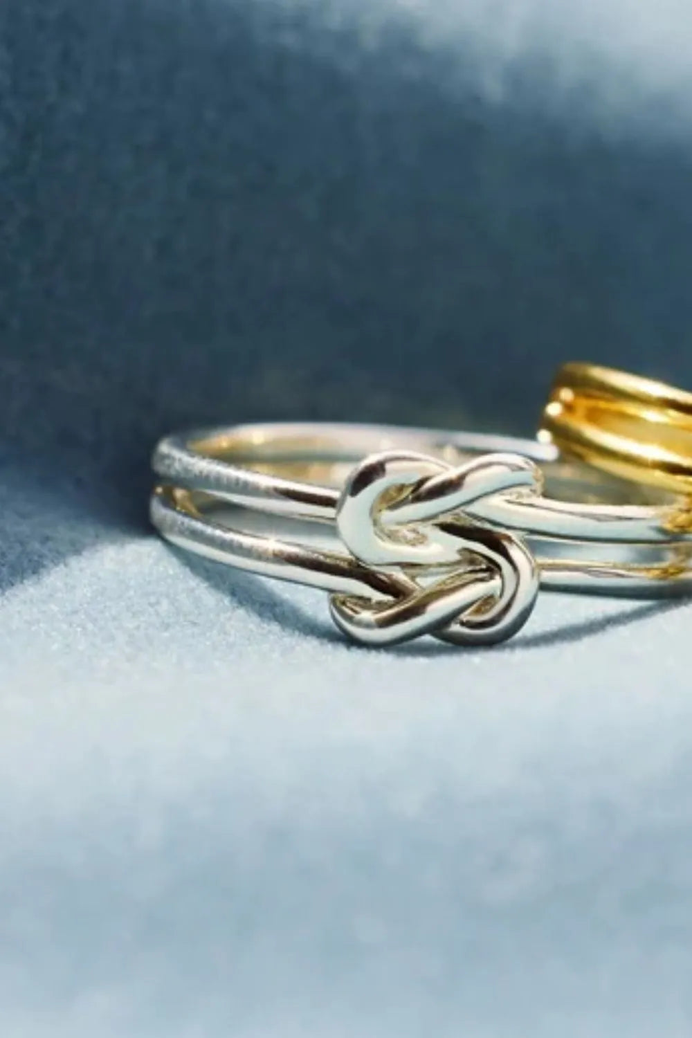 Sterling silver knotted ring from Plush Fashion Hub featuring a polished, intertwined design for elegant jewelry styling.