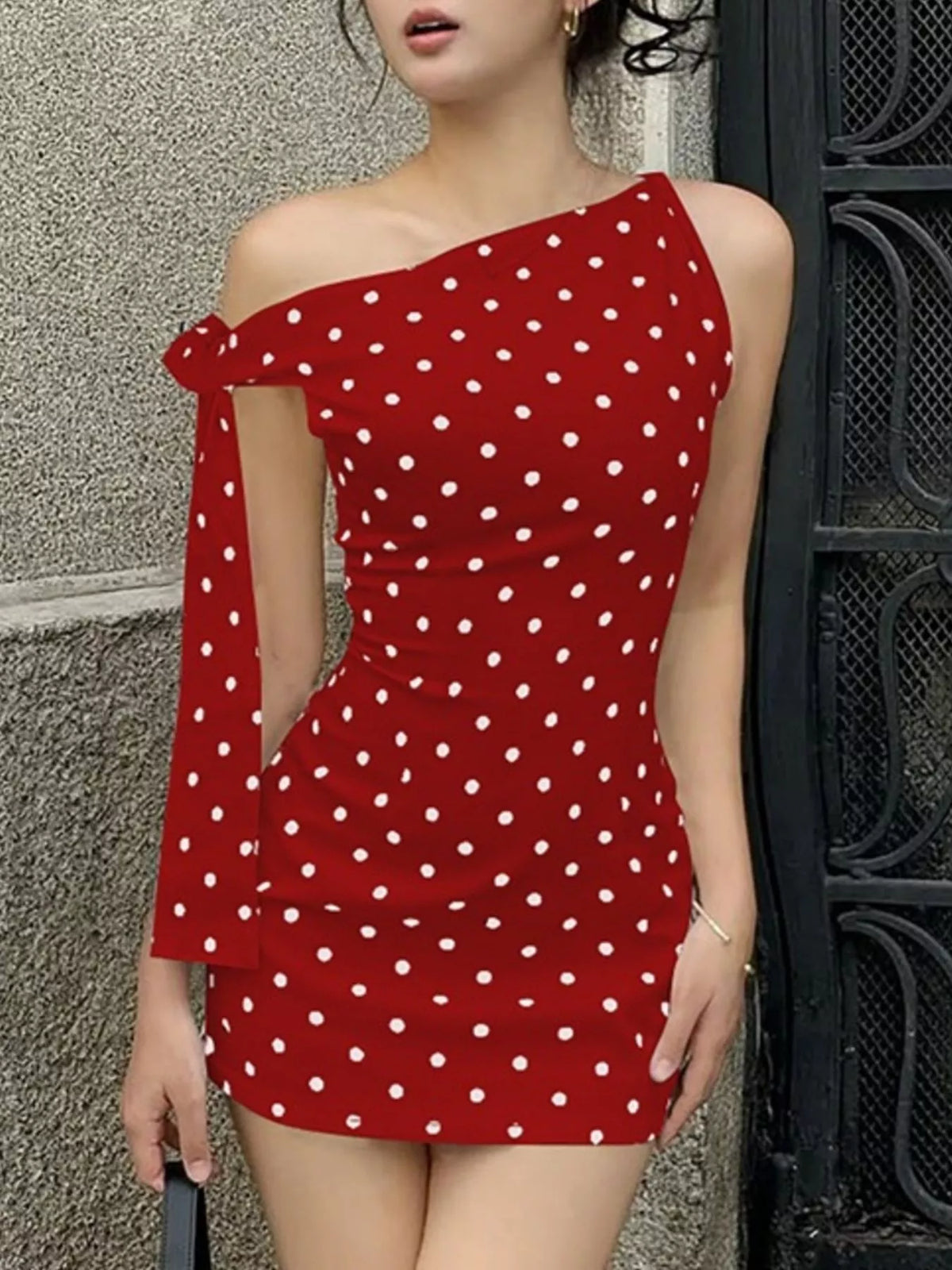 Polka dot sleeveless mini dress with bow accents from Plush Fashion Hub, showing the dress's playful design and fit.