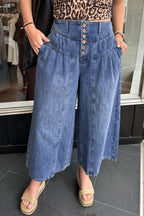 High-waisted wide-leg button-fly jeans in classic cotton denim, shown on a model with a casual outfit.