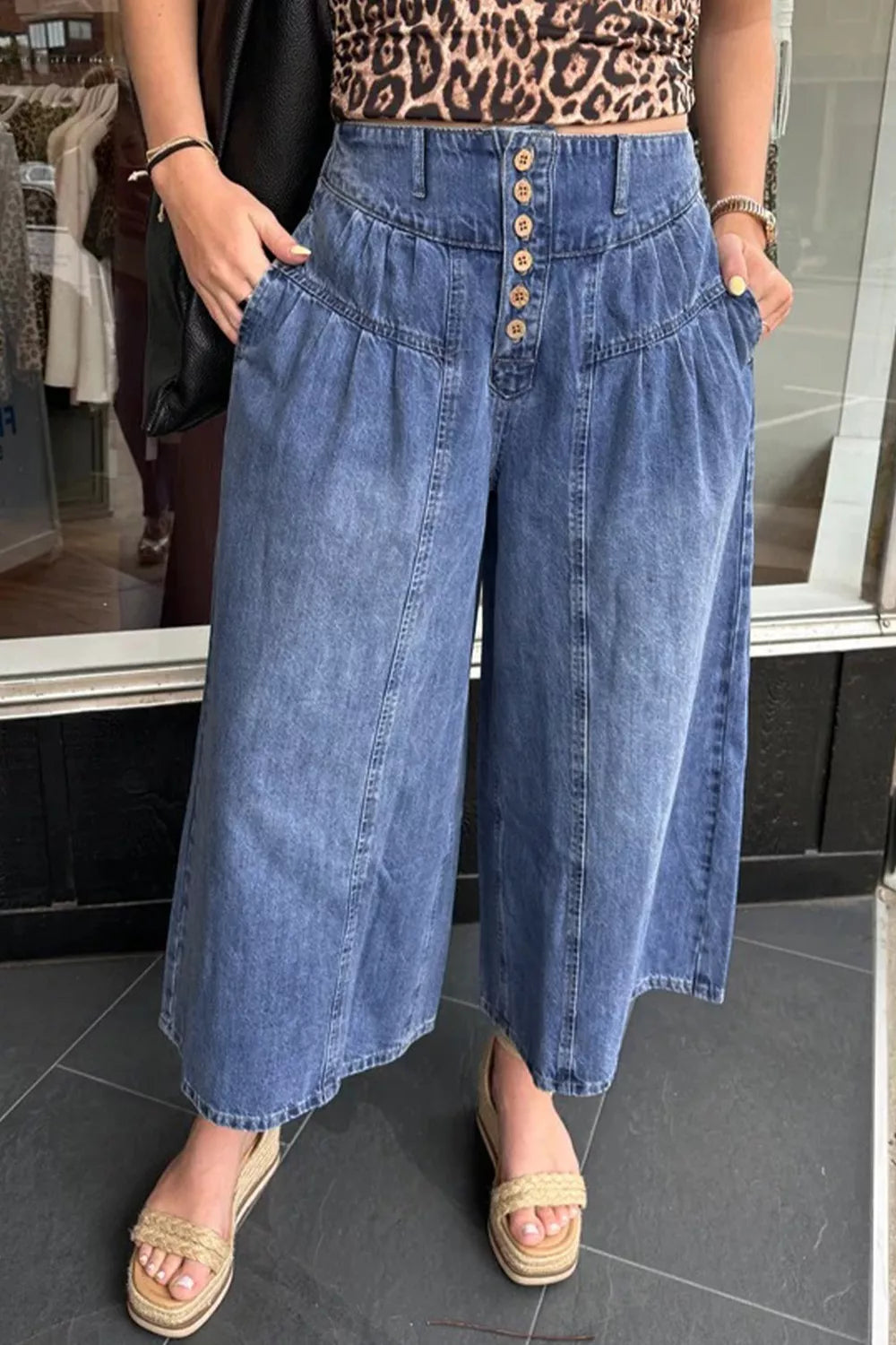 High-waisted wide-leg button-fly jeans in classic cotton denim, shown on a model with a casual outfit.