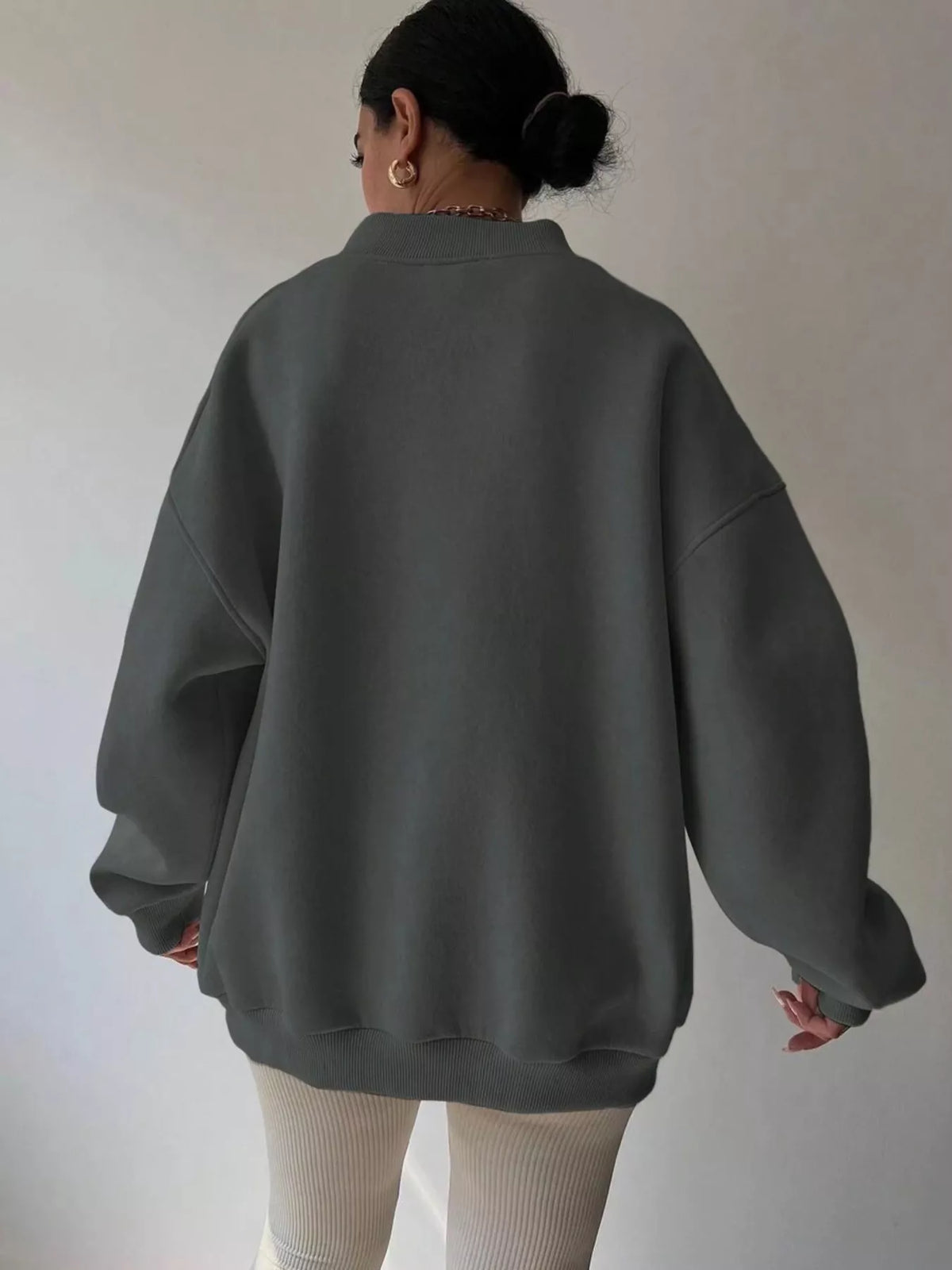 Oversized dropped shoulder long sleeve sweatshirt from Trendsi, showing a relaxed fit and cozy knit fabric in a neutral color.