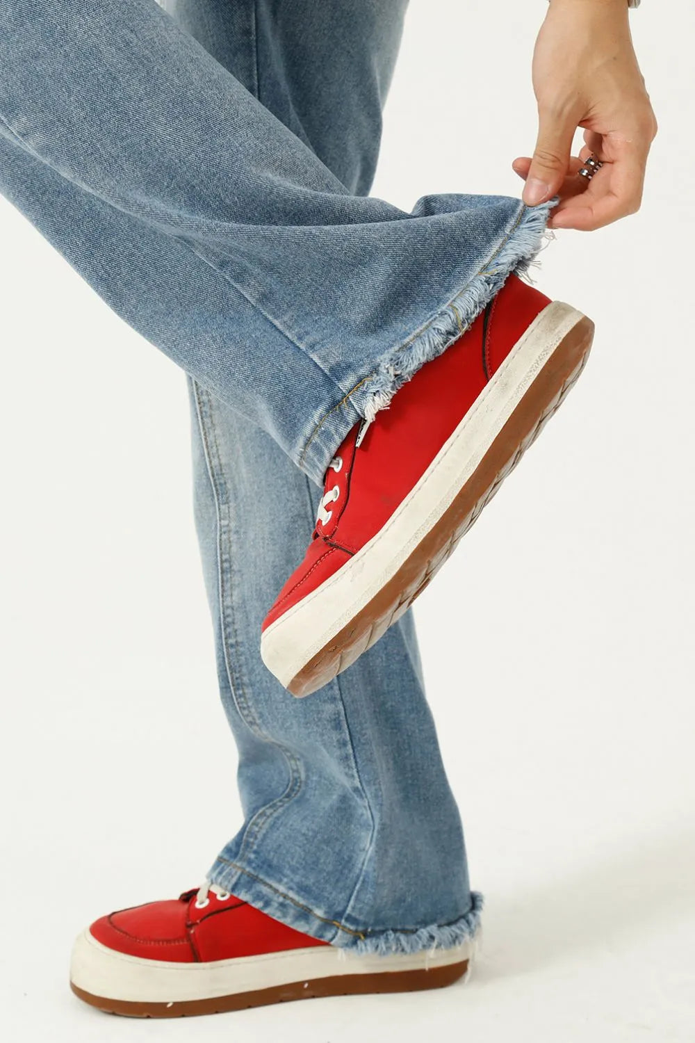 Raw hem denim jeans by Plush Fashion Hub featuring classic pockets and a casual fit, displayed on a neutral background.