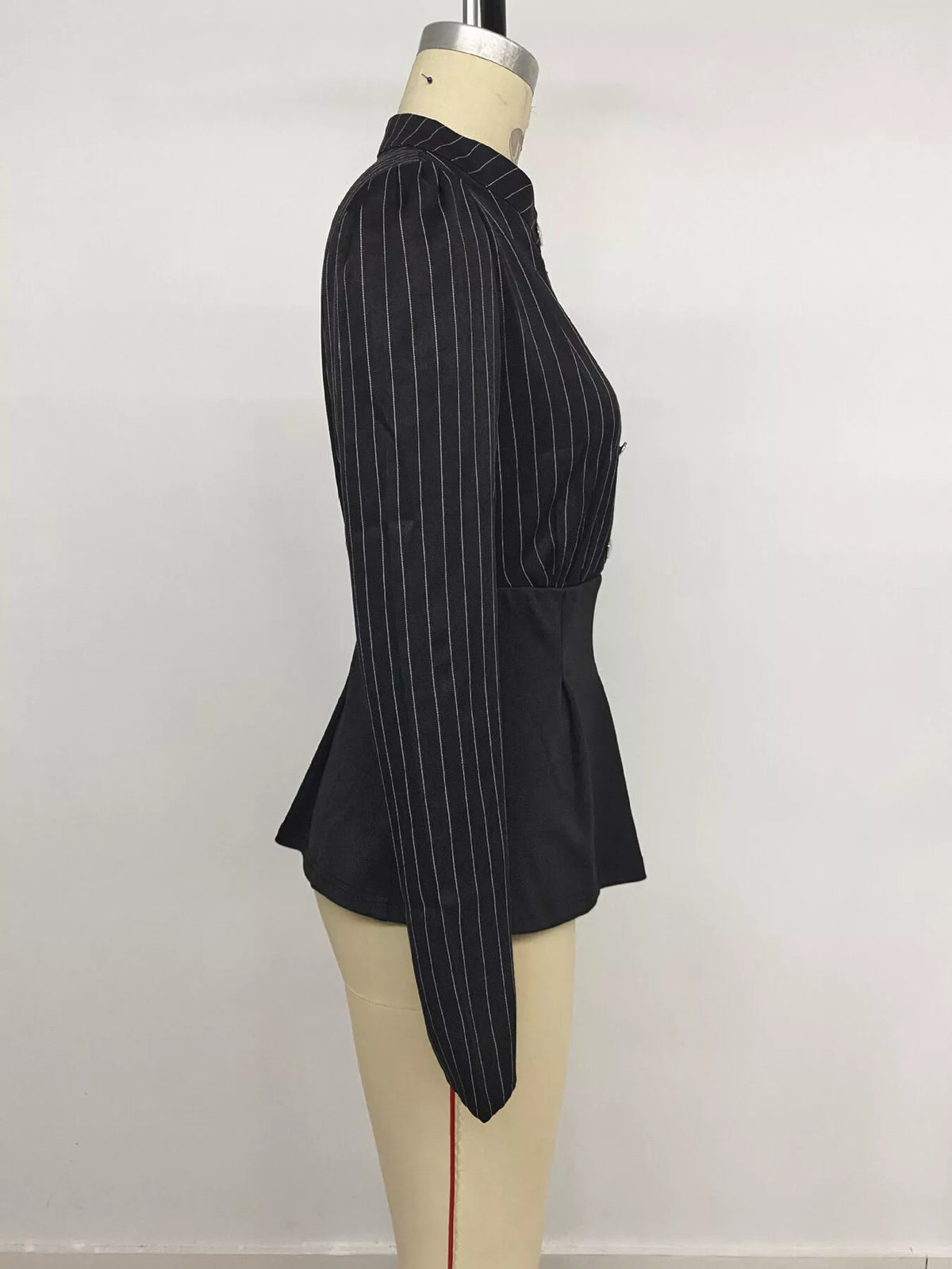 Striped long sleeve peplum blouse for women by Trendsi, featuring a fitted silhouette with stylish horizontal stripes.