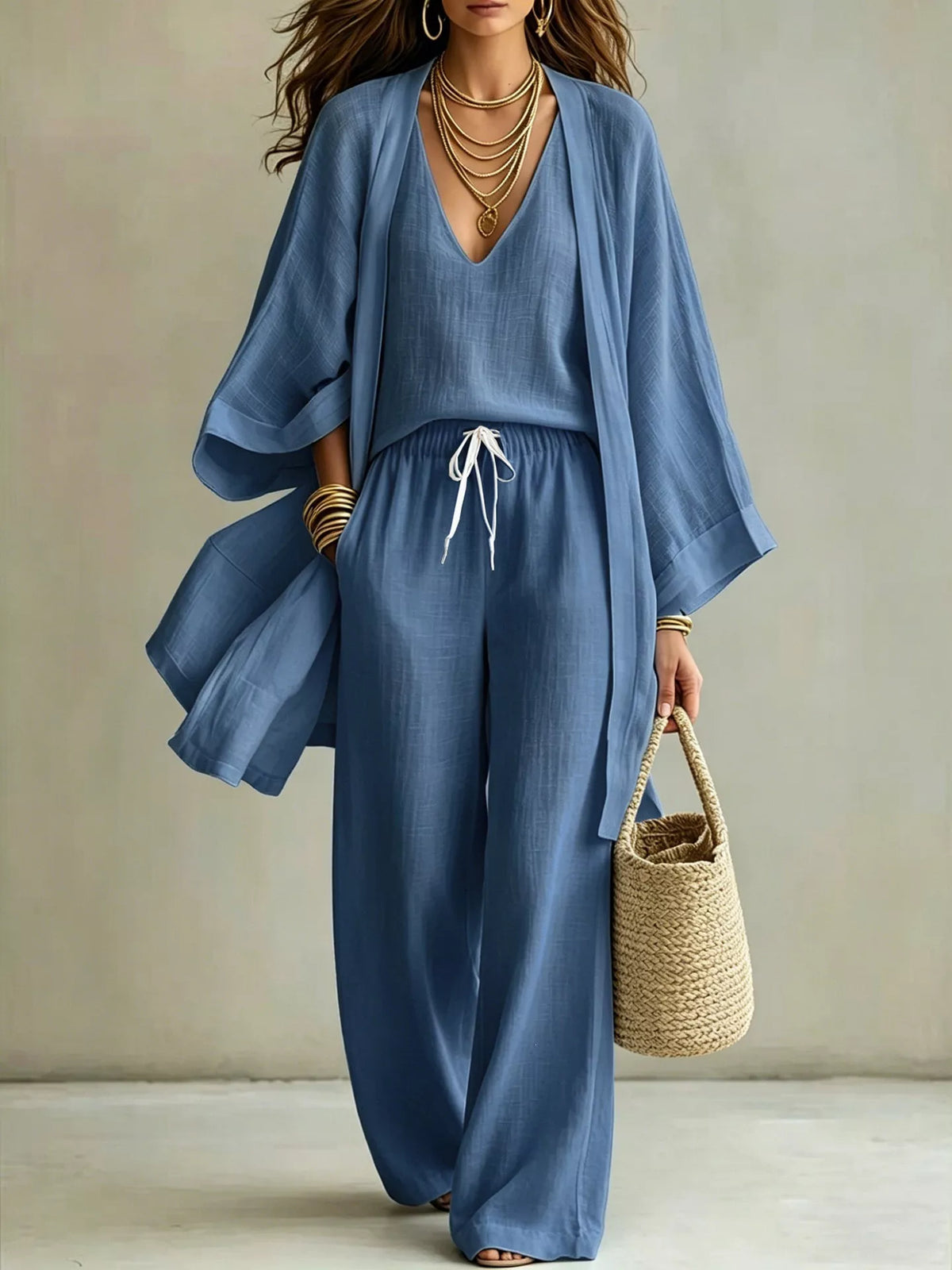 Plus size v-neck tank cardigan and pants loungewear set by Trendsi, featuring a comfortable, coordinated casual outfit.