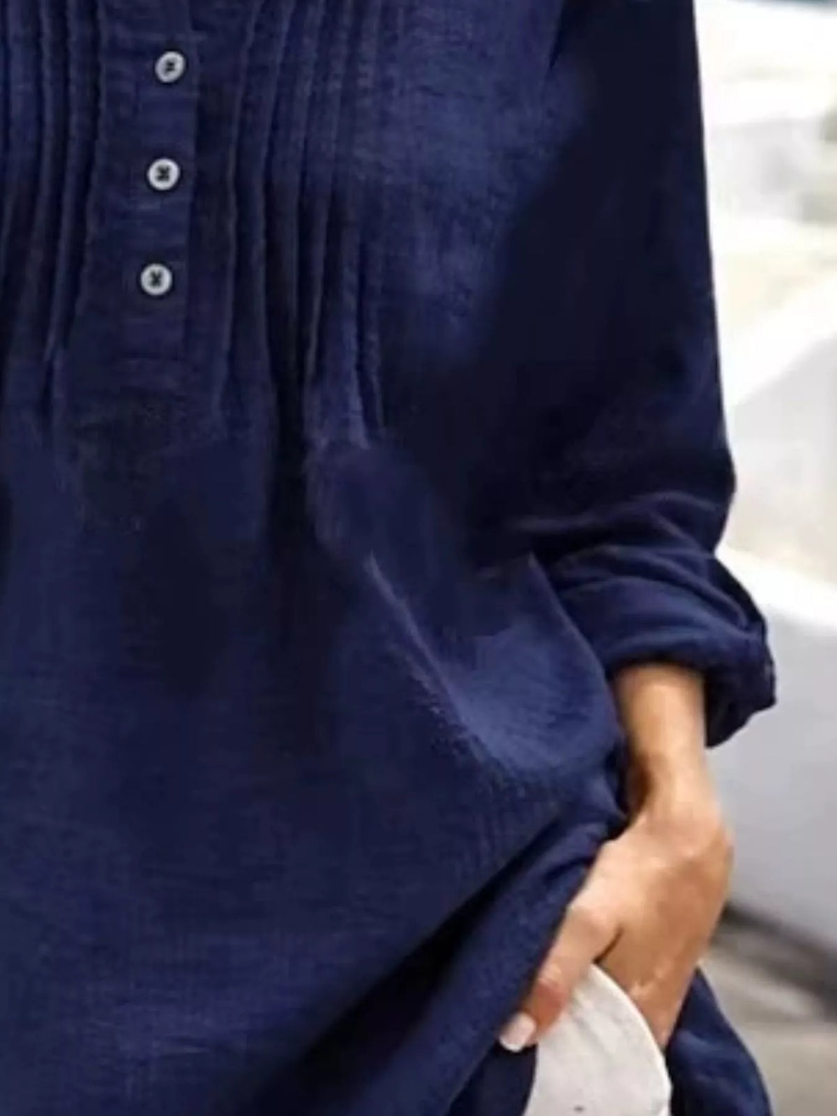 Casual long sleeve linen shirt with button details, featuring a relaxed fit and natural fabric texture from Trendsi.