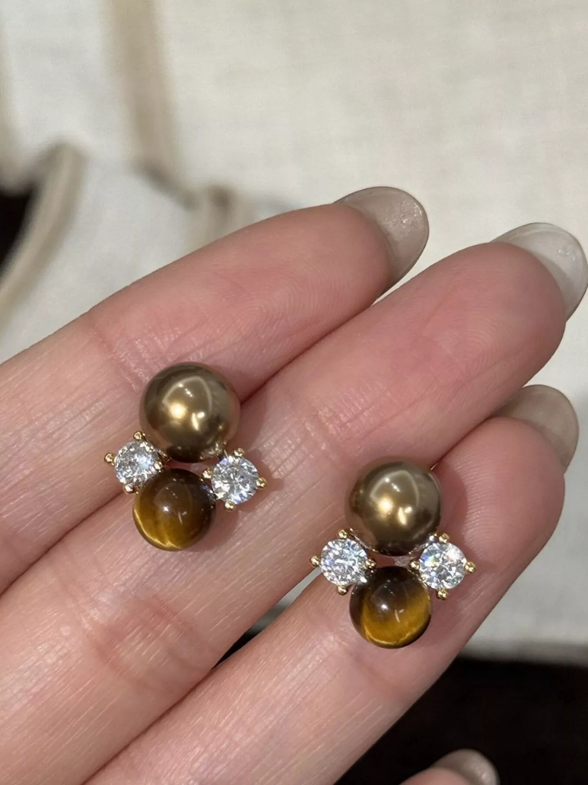 Tiger Eye stud earrings by Plush Fashion Hub featuring polished, natural gemstone with gold-tone setting on a white background.