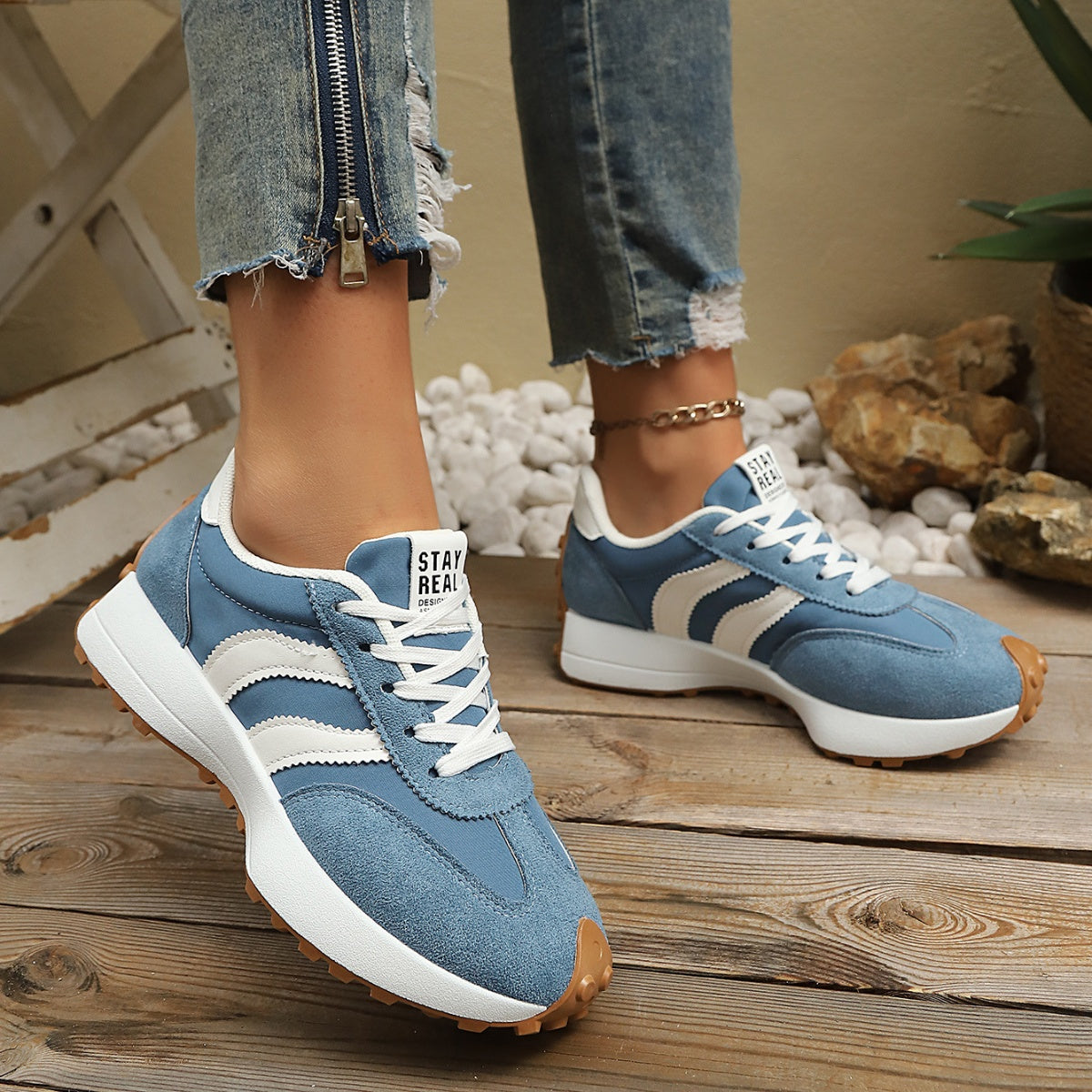 Women's round toe lace-up flat casual sneakers by Trendsi, made of comfortable PU leather, shown in a stylish side view.