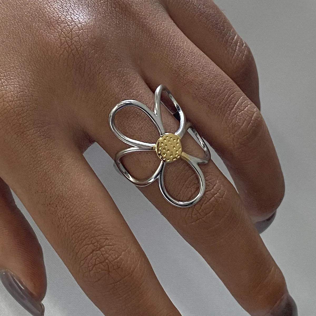 Two-tone daisy flower ring by Plush Fashion Hub featuring a delicate floral design on a sleek band.