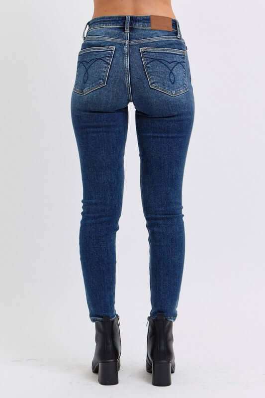 Judy Blue Full Size Run Mid-Rise Waist Skinny Jeans with Thermal Lining, back view.