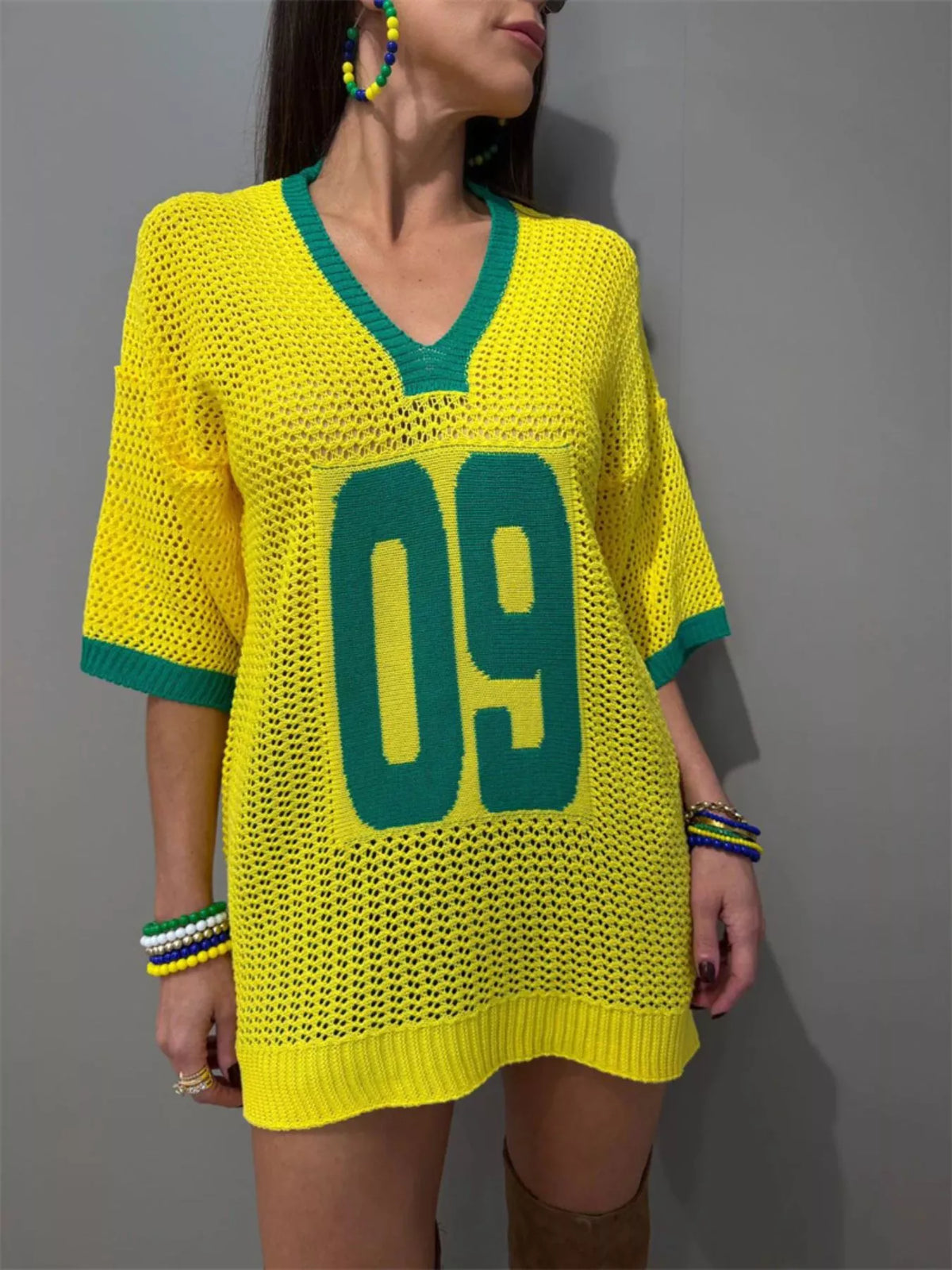 Lightweight women's oversized V-neck openwork knit sweater by Plush Fashion Hub, showing the textured open-knit pattern and relaxed fit.