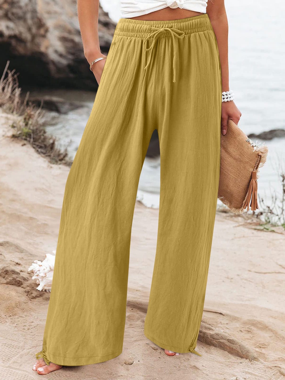 Plus size full length wide leg pants with drawstring waist from Trendsi, shown in a relaxed fit with flowing fabric.