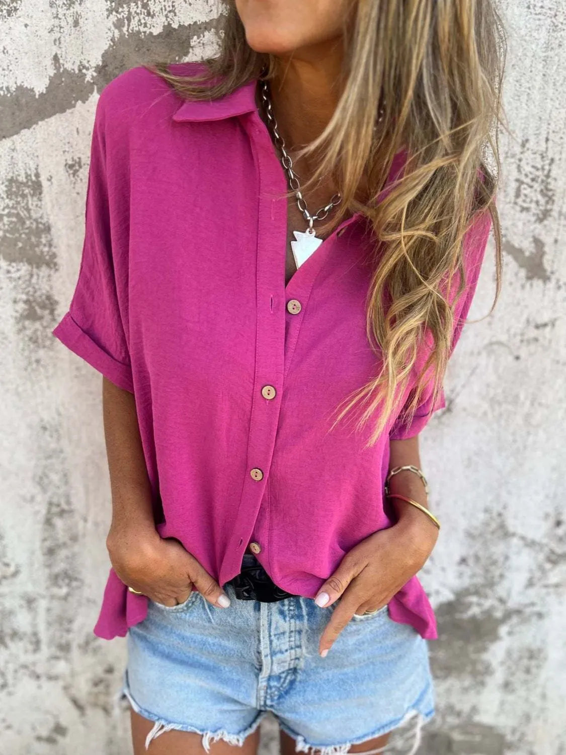 Women's collared button-down office blouse in half sleeve style by Plush Fashion Hub, shown in a professional top.