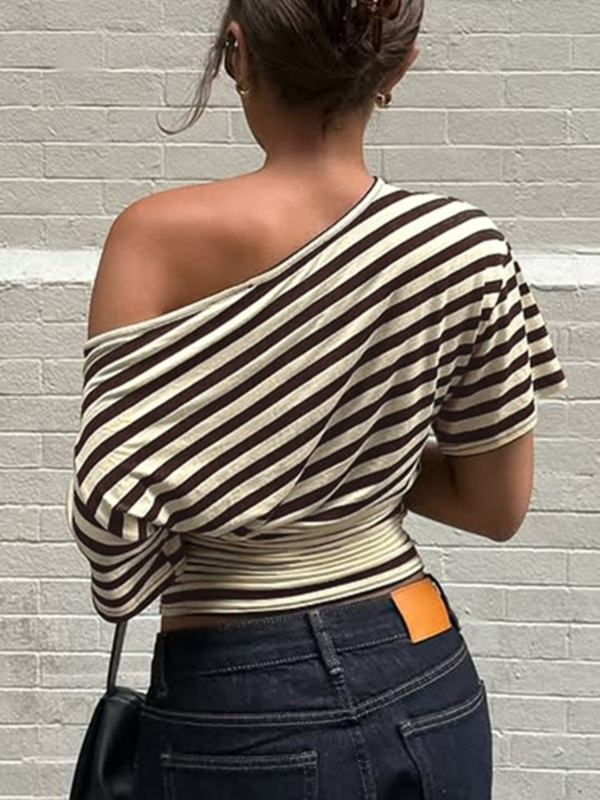 Women's asymmetrical striped one-shoulder T-shirt from Plush Fashion Hub, featuring bold horizontal stripes and a stylish one-shoulder design.