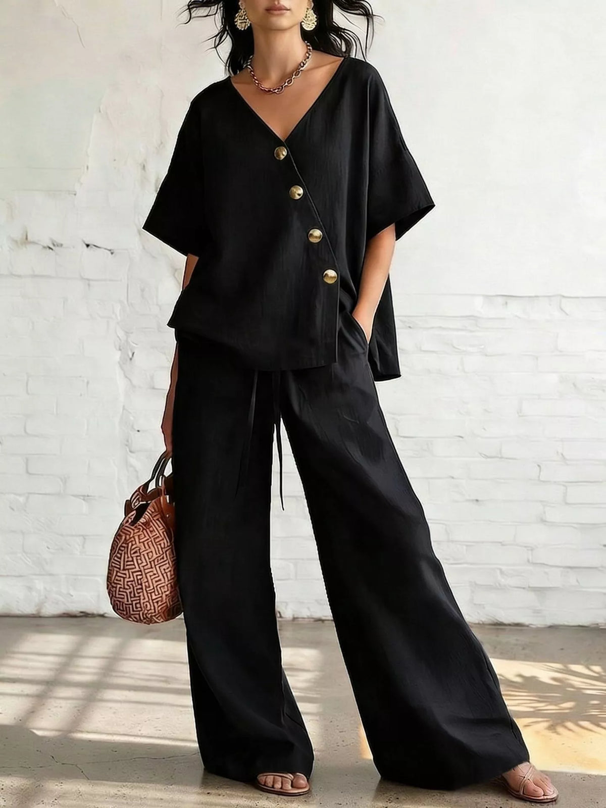 Plus size full surplice half-sleeve top and wide-leg pants matching set by Trendsi, shown in a stylish, coordinated outfit.