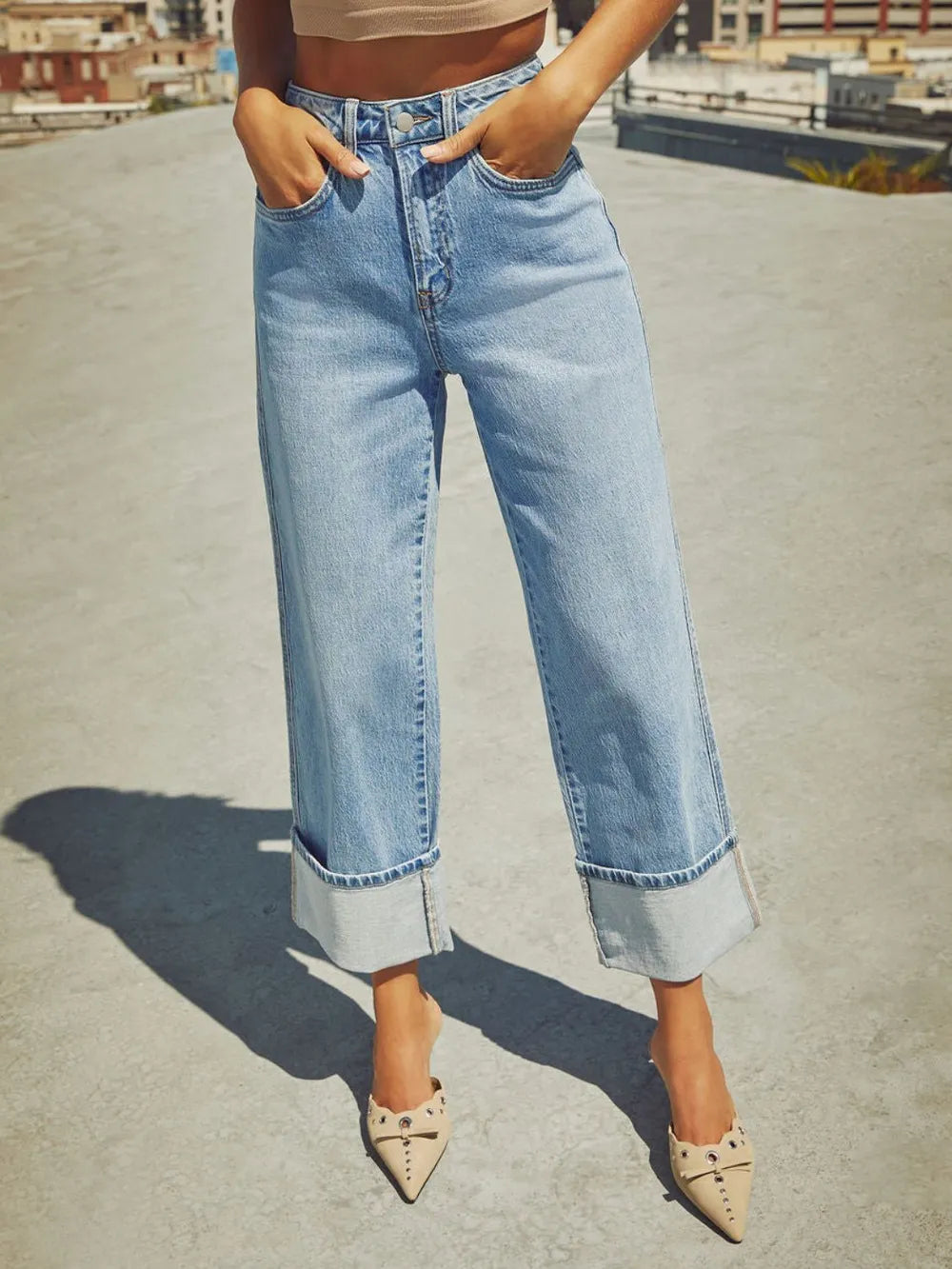 Trendsi high-waisted straight-leg rolled denim jeans displayed on a hanger, showcasing classic blue denim and rolled cuffs.