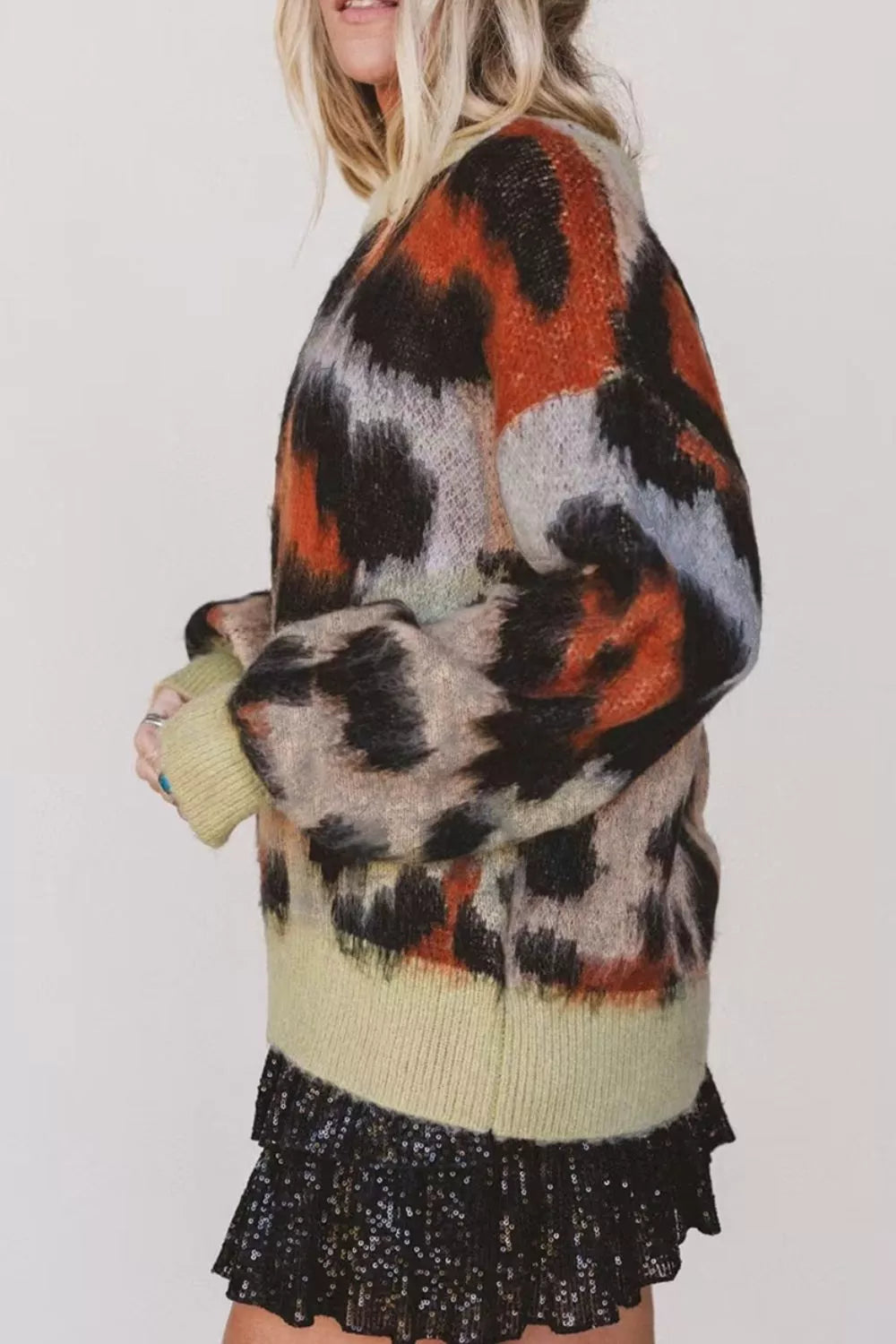 Leopard print drop shoulder long sleeve sweater with round neck from Trendsi, featuring cozy knit fabric and stylish animal print design.