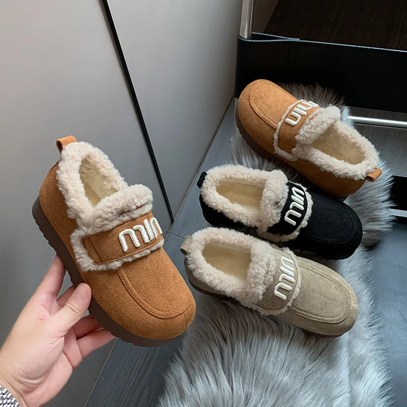 Faux fur suede round toe slip-on footwear by Trendsi, featuring a cozy and stylish design with a comfortable slip-on style.