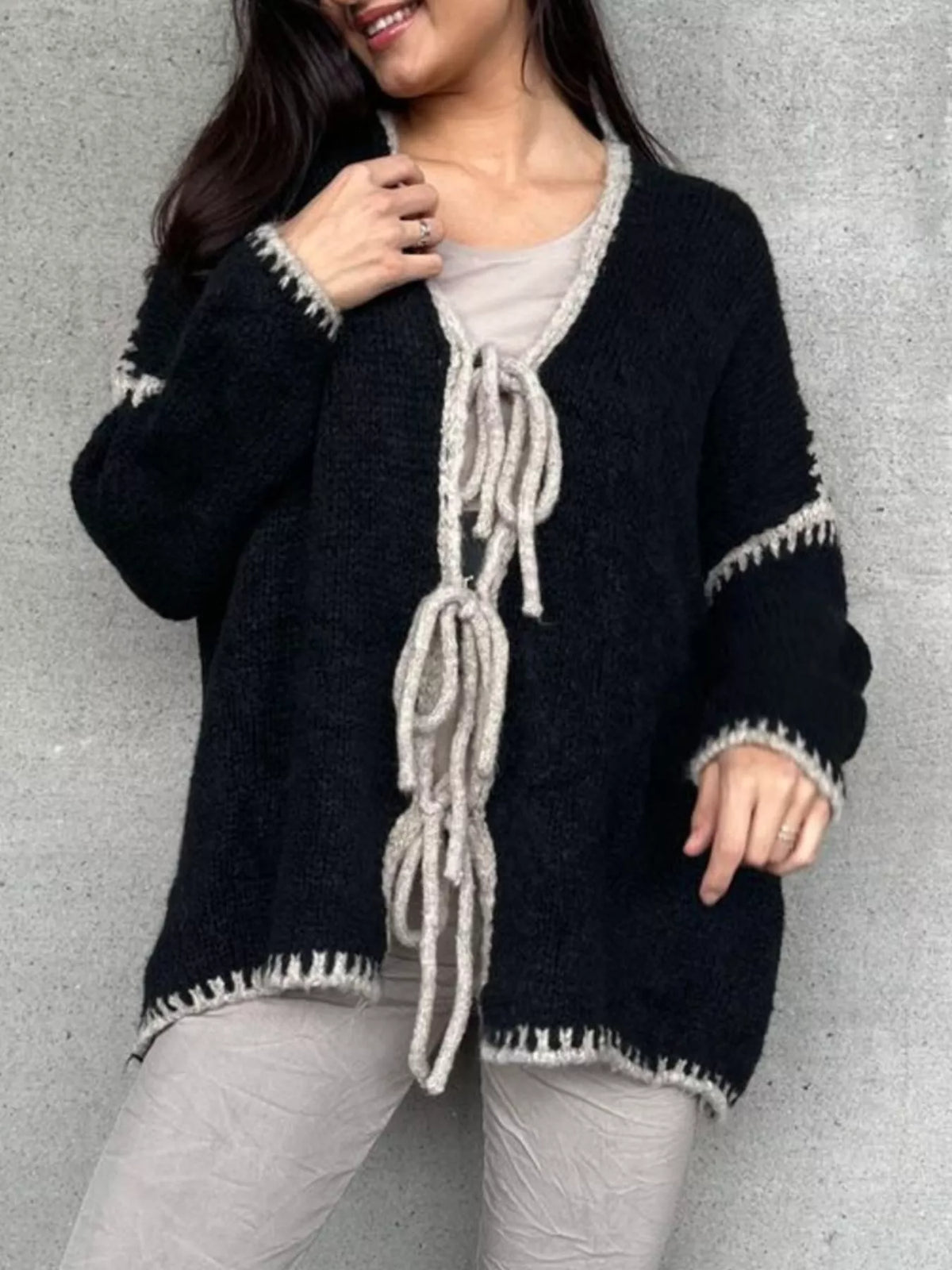 Tie front drop shoulder cardigan by Trendsi, soft knit fabric, featuring a relaxed fit with a tie-front closure and drop shoulder design.