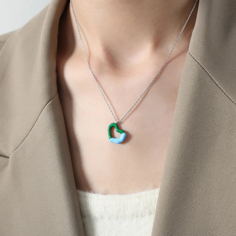 Titanium steel heart pendant necklace with sleek design, featuring a polished silver finish, crafted by Plush Fashion Hub.