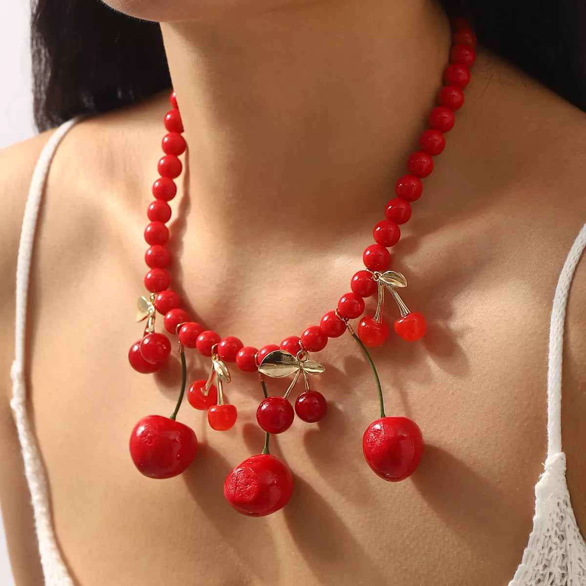 Cherry charm beaded statement necklace from Plush Fashion Hub featuring vibrant red cherry beads and intricate beaded design.