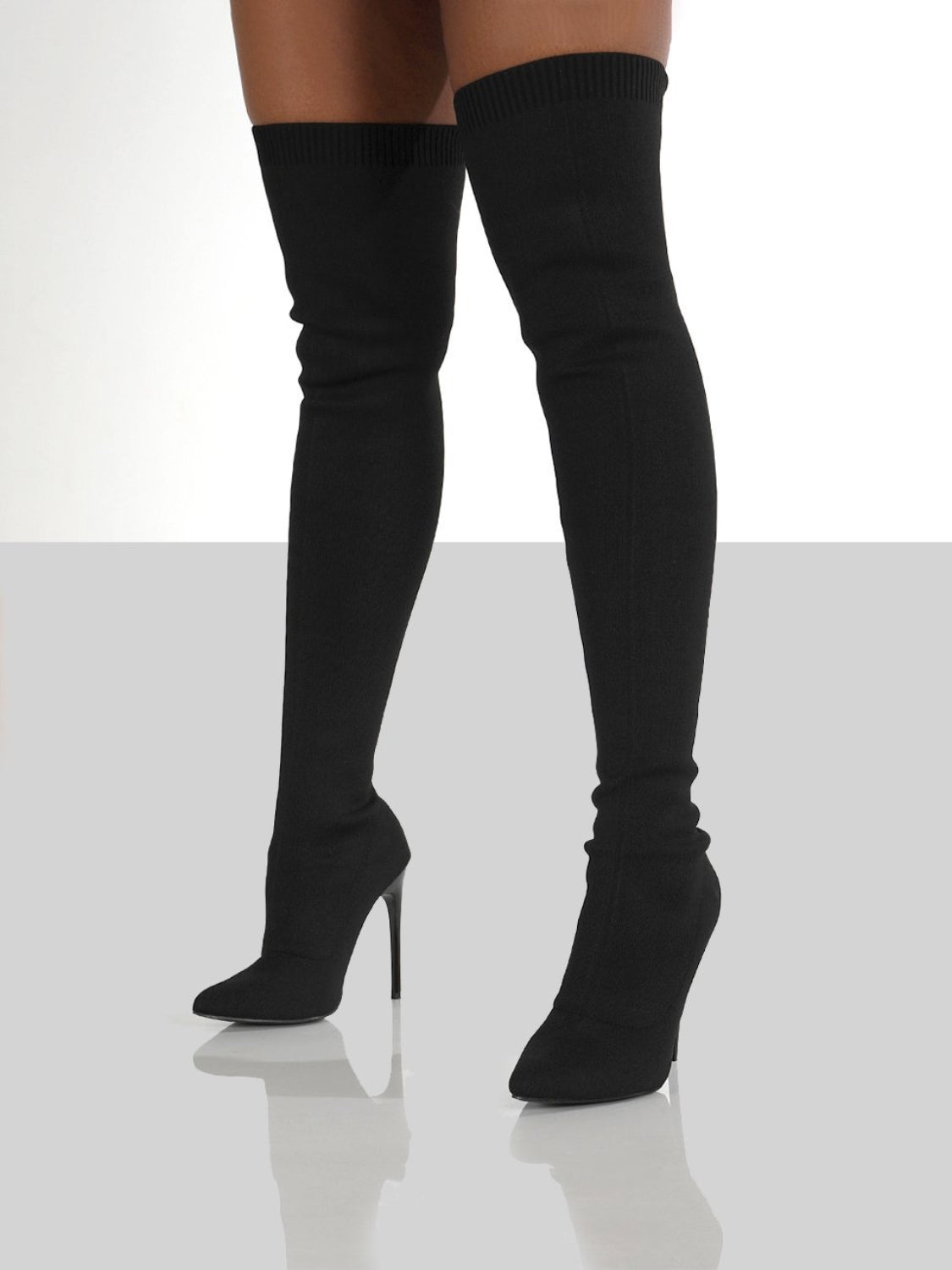 Black point toe over knee stiletto boots with high heel for women.