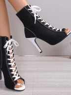 Canvas lace-up peep toe stiletto ankle boots featuring cutout design and high heels, stylish shoes by Trendsi.