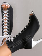 Trendsi canvas lace-up peep toe stiletto ankle boots with cutout design and high heels, stylish and modern footwear.