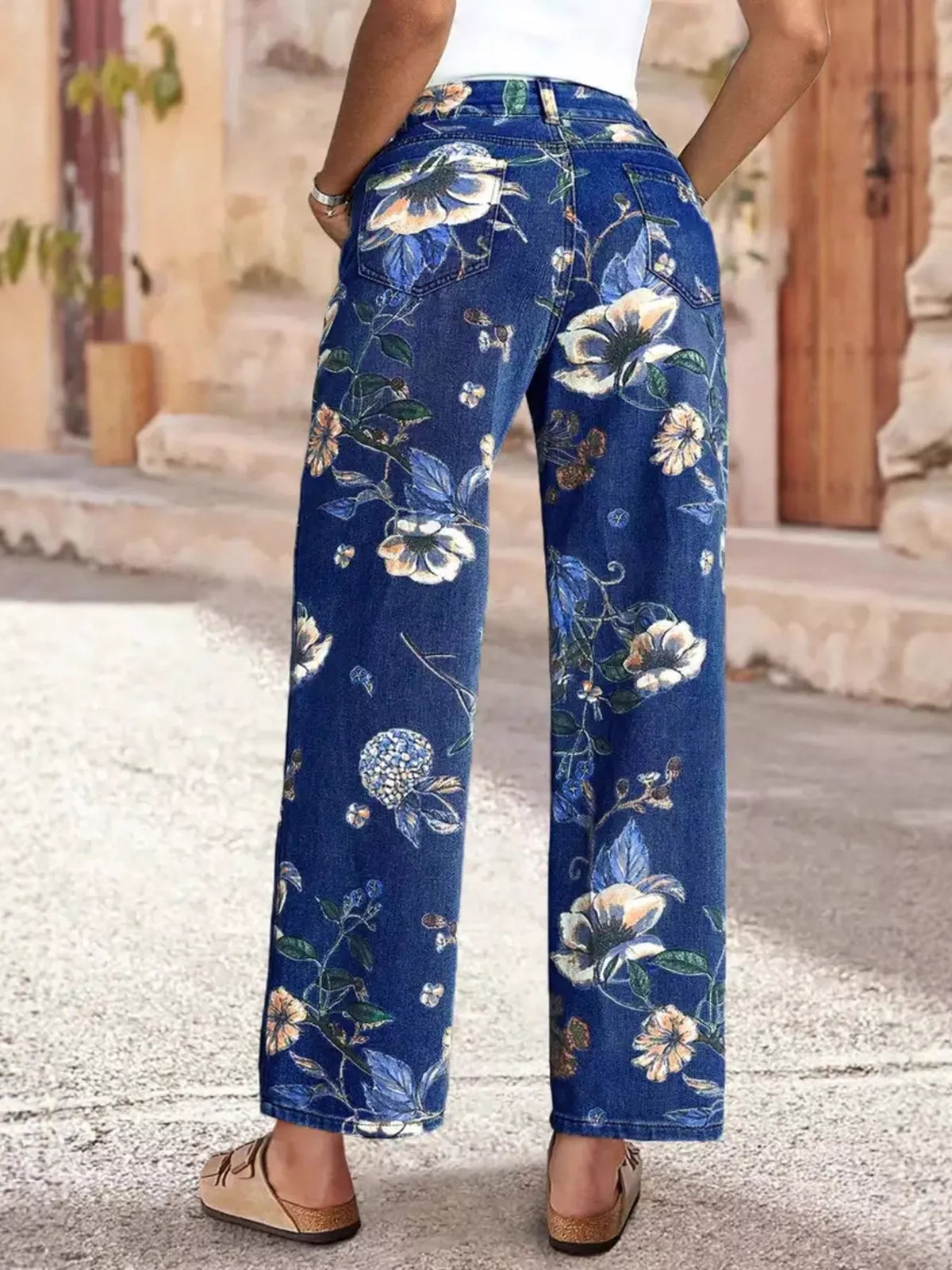 Floral print wide-leg jeans from Plush Fashion Hub featuring colorful flower patterns and a relaxed fit, casual bottoms for stylish comfort.