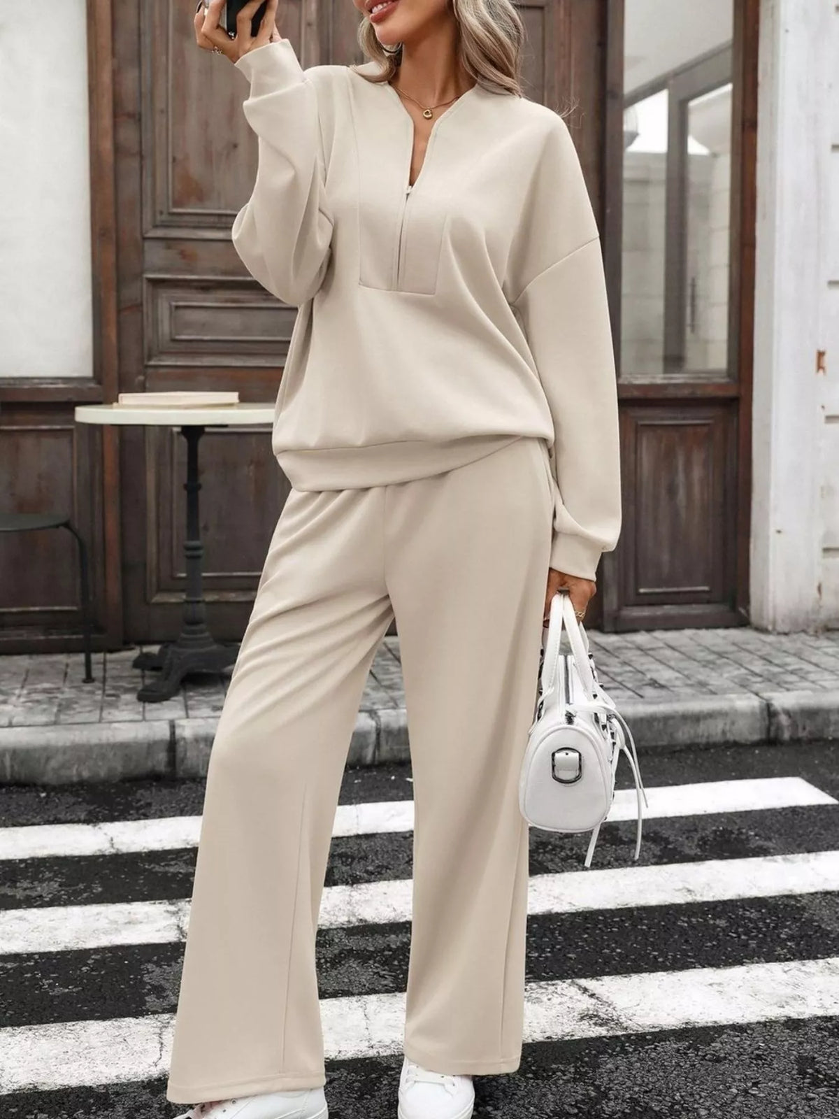 Women’s half zip sweatshirt and wide-leg pants set by Trendsi, featuring a cozy top and comfortable loose-fit pants.