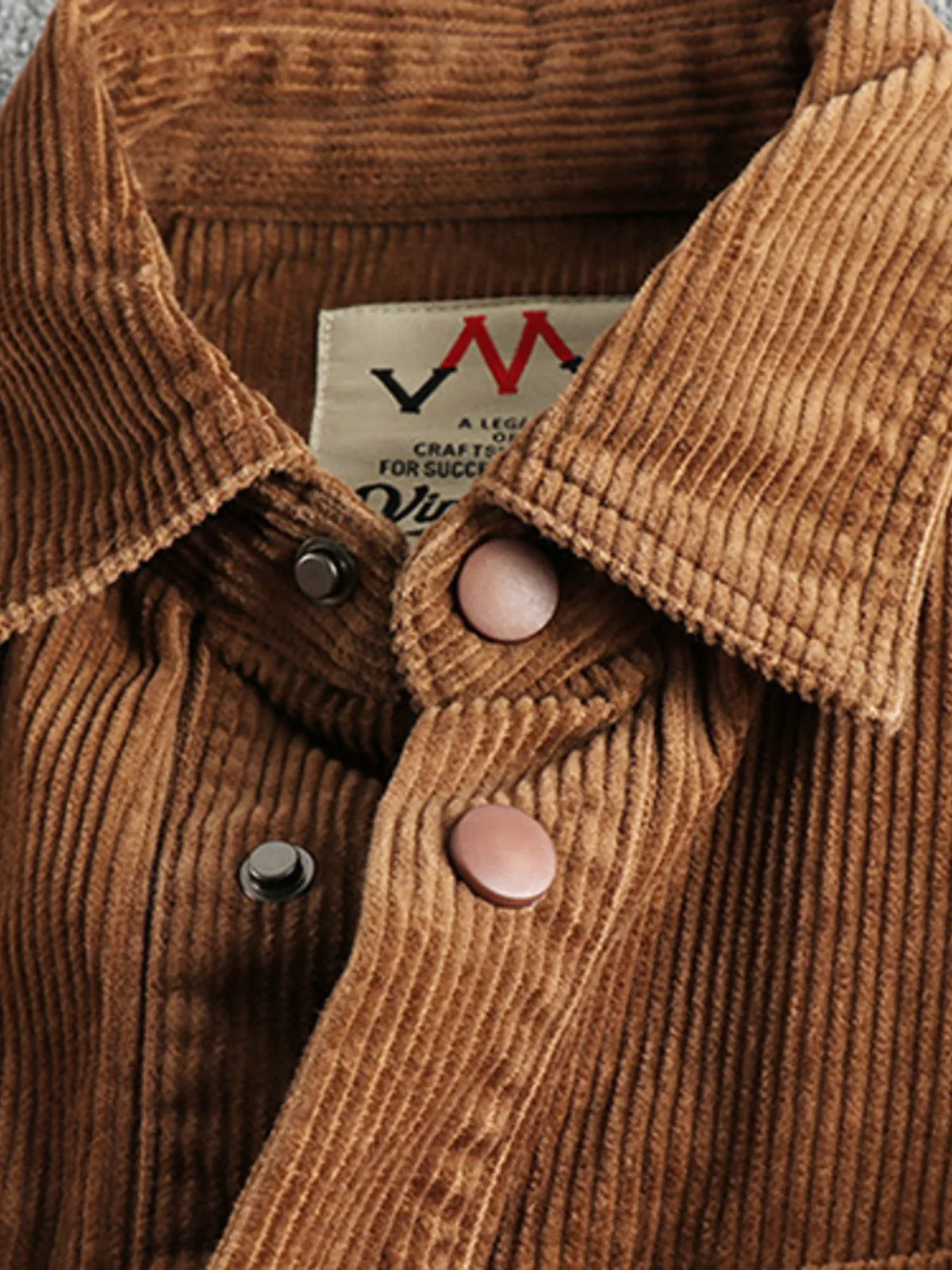 Plus size men's corduroy button-up long sleeve jacket by Trendsi, shown in a close-up of the textured brown fabric.