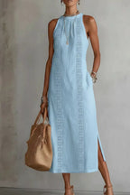 Women's sleeveless maxi dress with side slit and pockets by Trendsi, flowing fabric, elegant design for summer or casual wear.