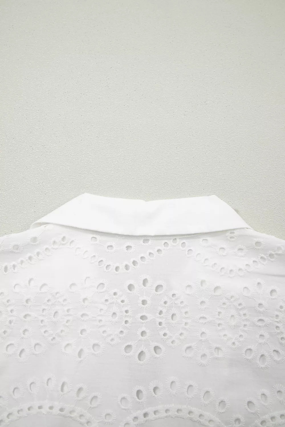 Solid color eyelet embroidered T-shirt mini dress by Plush Fashion Hub, featuring eyelet details and a relaxed fit.