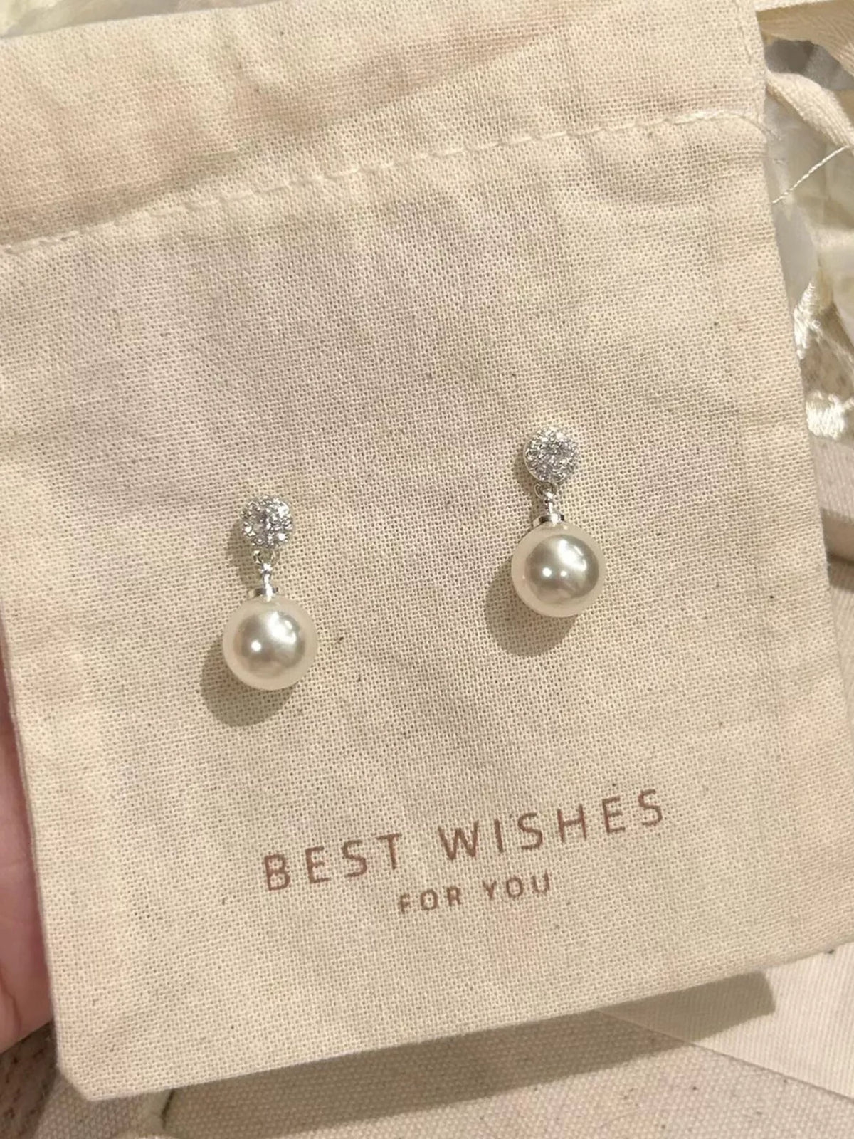 Elegant classic pearl drop earrings from Plush Fashion Hub featuring lustrous pearls and a sleek design.