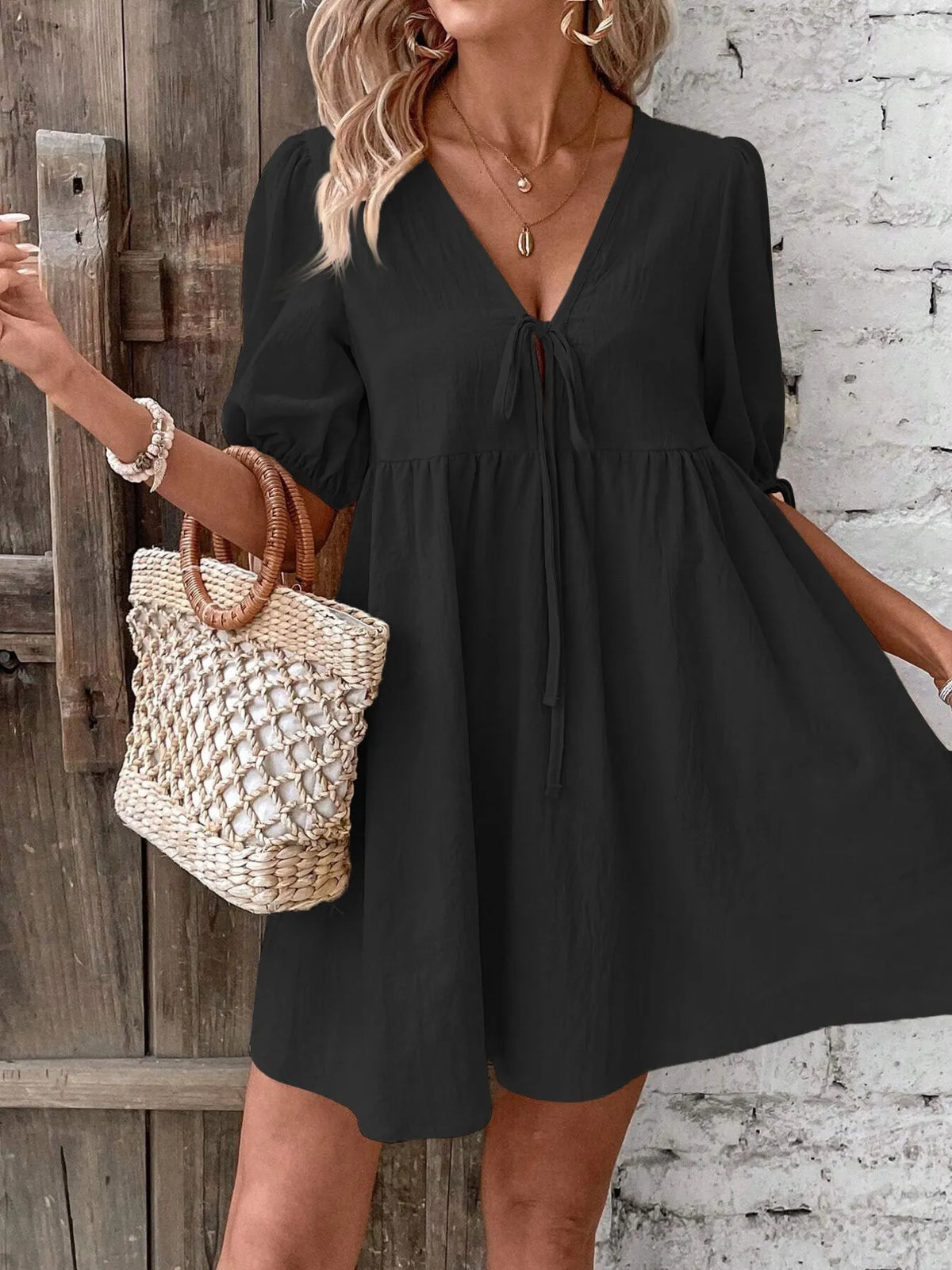 Cotton V-neck tie-front mini dress with puff sleeves by Plush Fashion Hub, shown on a hanger against a neutral background.
